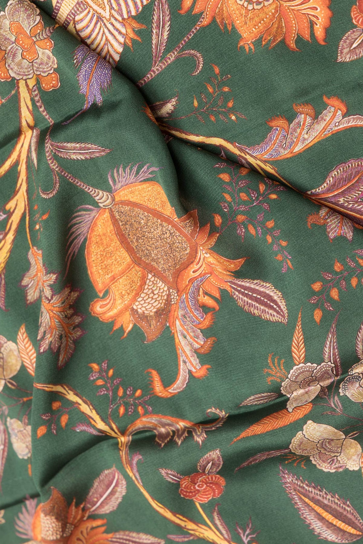 Close up of Bottle Green Dual Tone Mysore Crepe Saree with Printed design on the body and Zari Border.  displaying folds