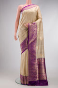 Beige Dual Tone Tussar Silk Saree with Zari Butta on the body and Zari And Thread Border.  displayed on a mannequin