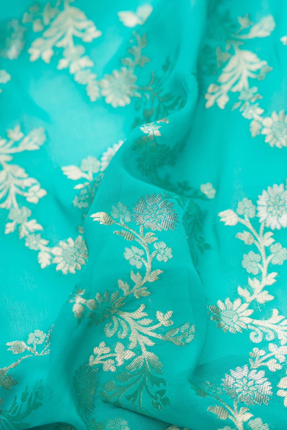 Close up of Sky Blue Dual Tone Banarasi Georgette Saree with Zari Brocade on the body and Zari Border.  displaying folds