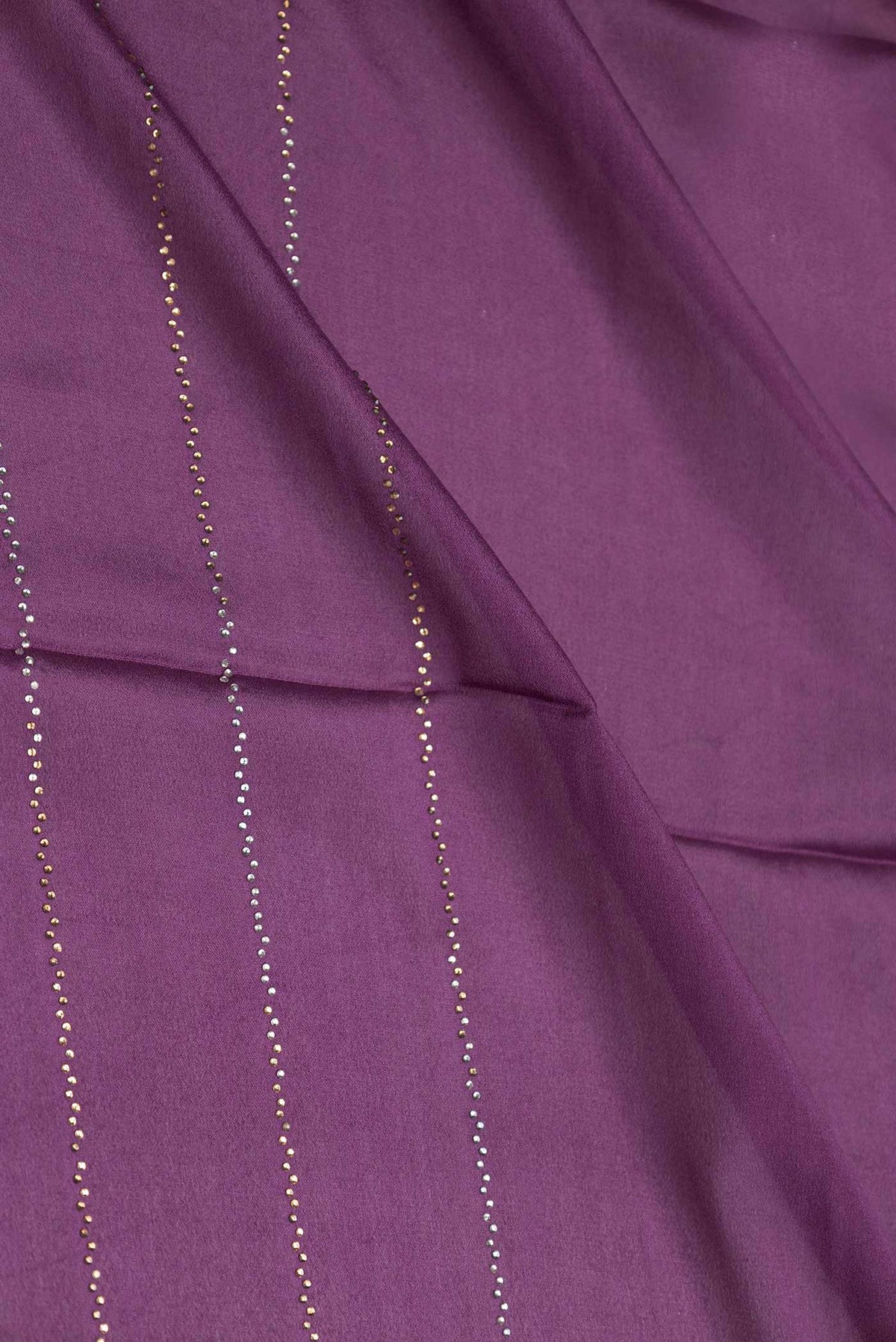 Close up of Burgundy Dual Tone Mysore Crepe Saree with Embroidery on the body and Zari Border displaying folds