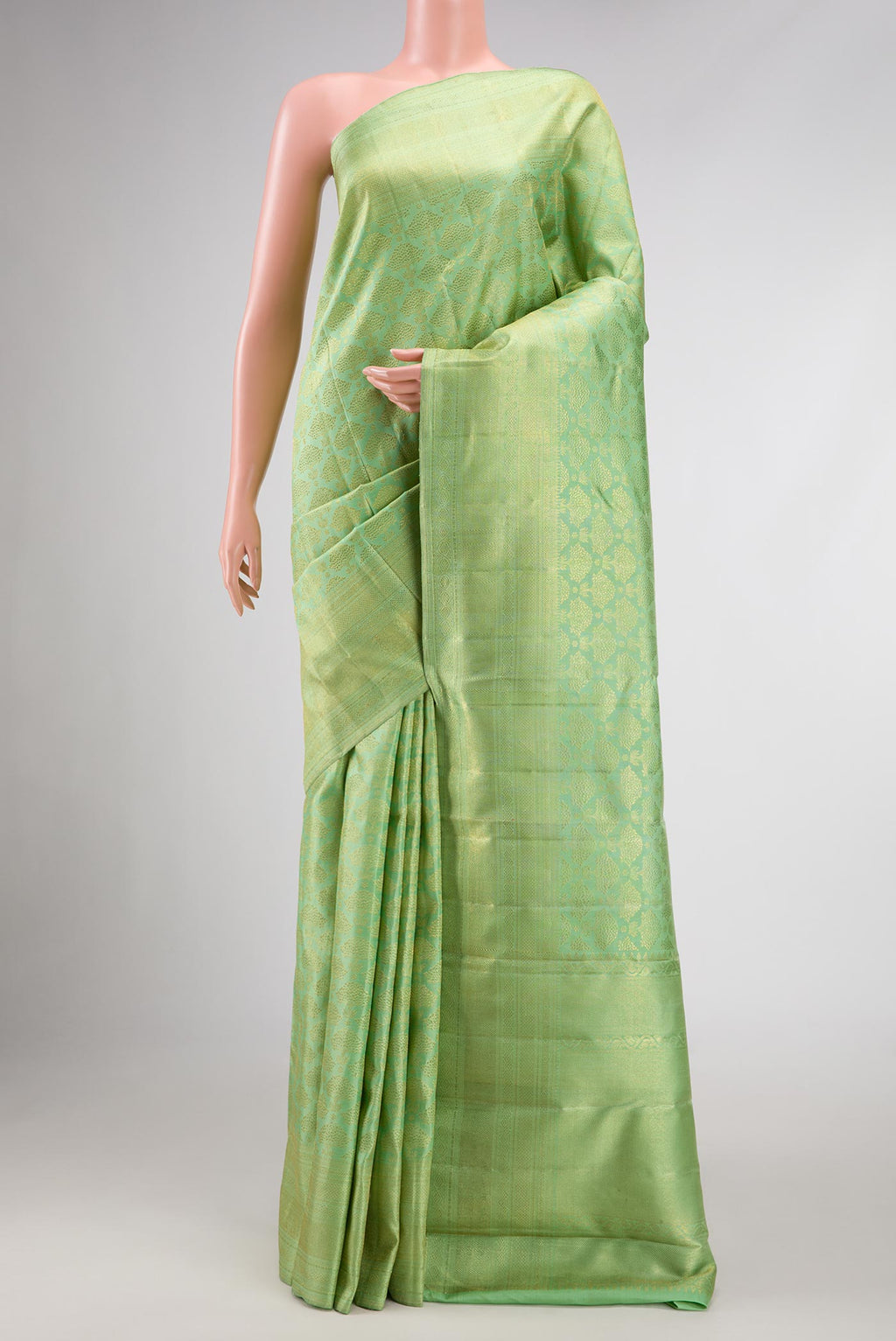 Pista Green Dual Tone Kanchipuram Silk Saree with Zari Brocade on the body and Zari Border displayed on a mannequin