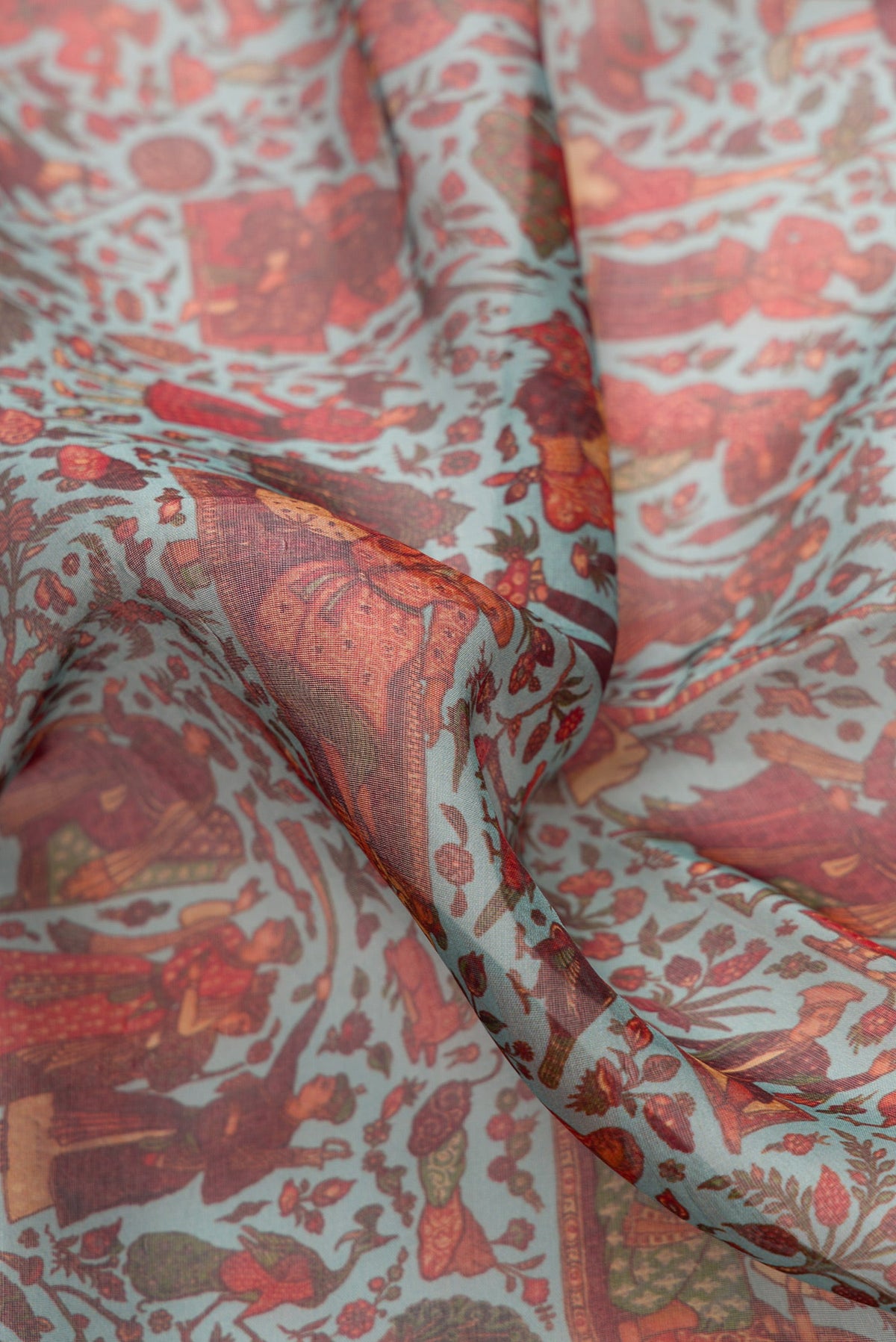 Close up of Light Green Dual Tone Organza Silk Saree with Printed design on the body and Zari Border.  displaying folds