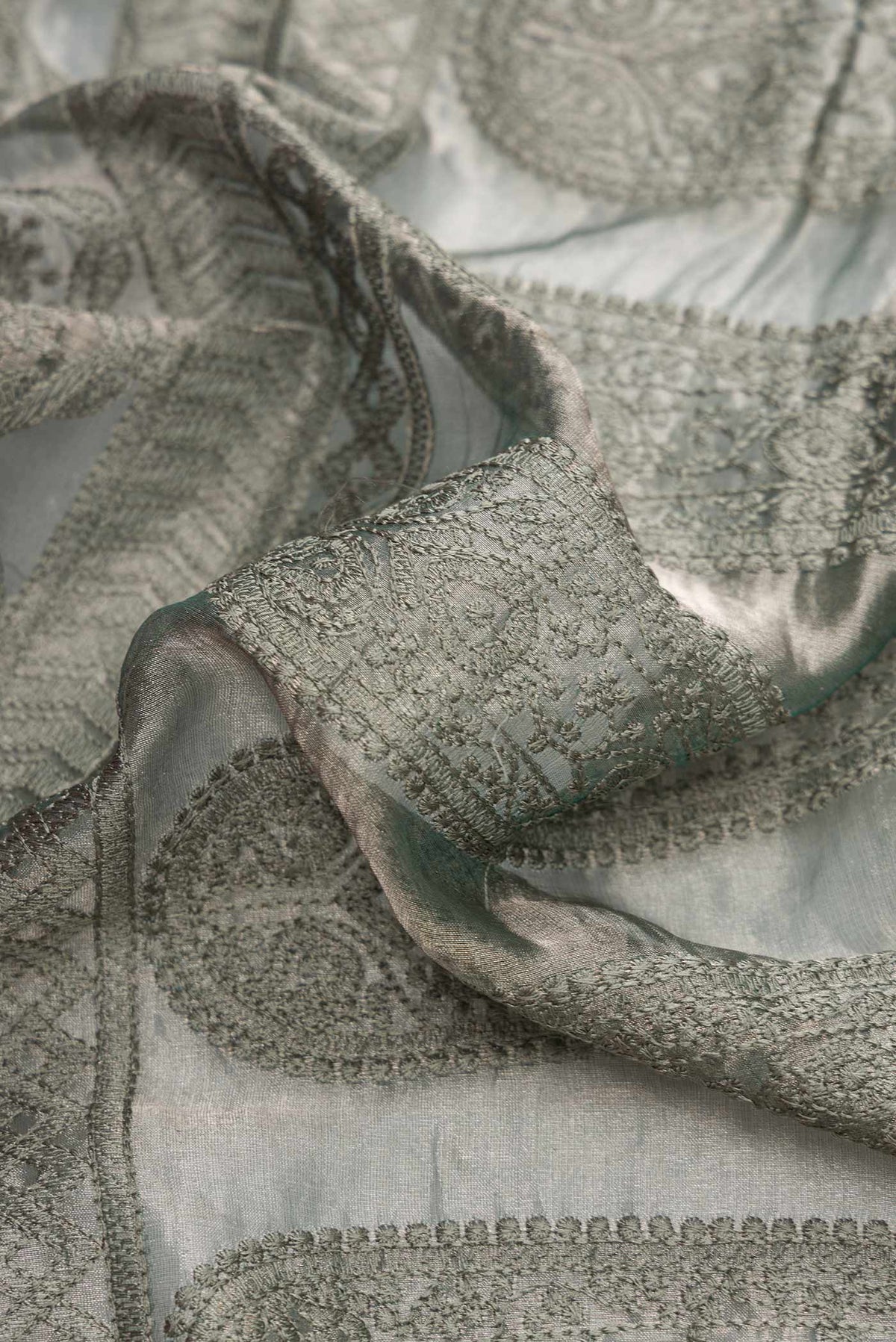 Close up of Grey Dual Tone Mysore Georgette Saree with Embroidery on the body and Plain Border.  displaying folds