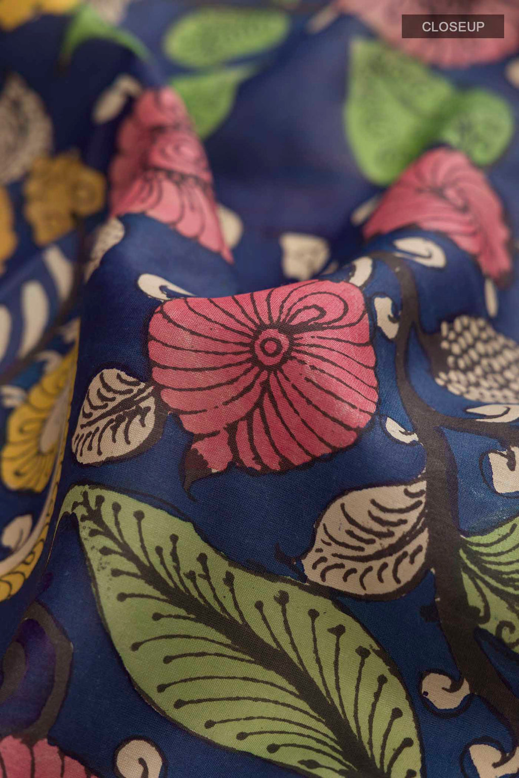 Close up of Blue Kanchipuram Silk Saree with Printed design on the body and Zari Border displaying folds