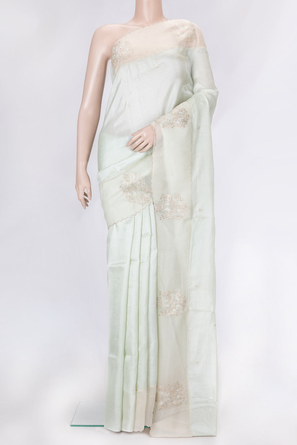 Pista Green Dual Tone Tussar Silk Saree with Embroidery on the body and Fancy Border.  displayed on a mannequin