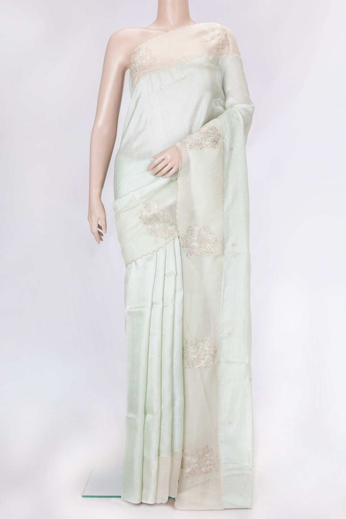 Pista Green Dual Tone Tussar Silk Saree with Embroidery on the body and Fancy Border.  displayed on a mannequin