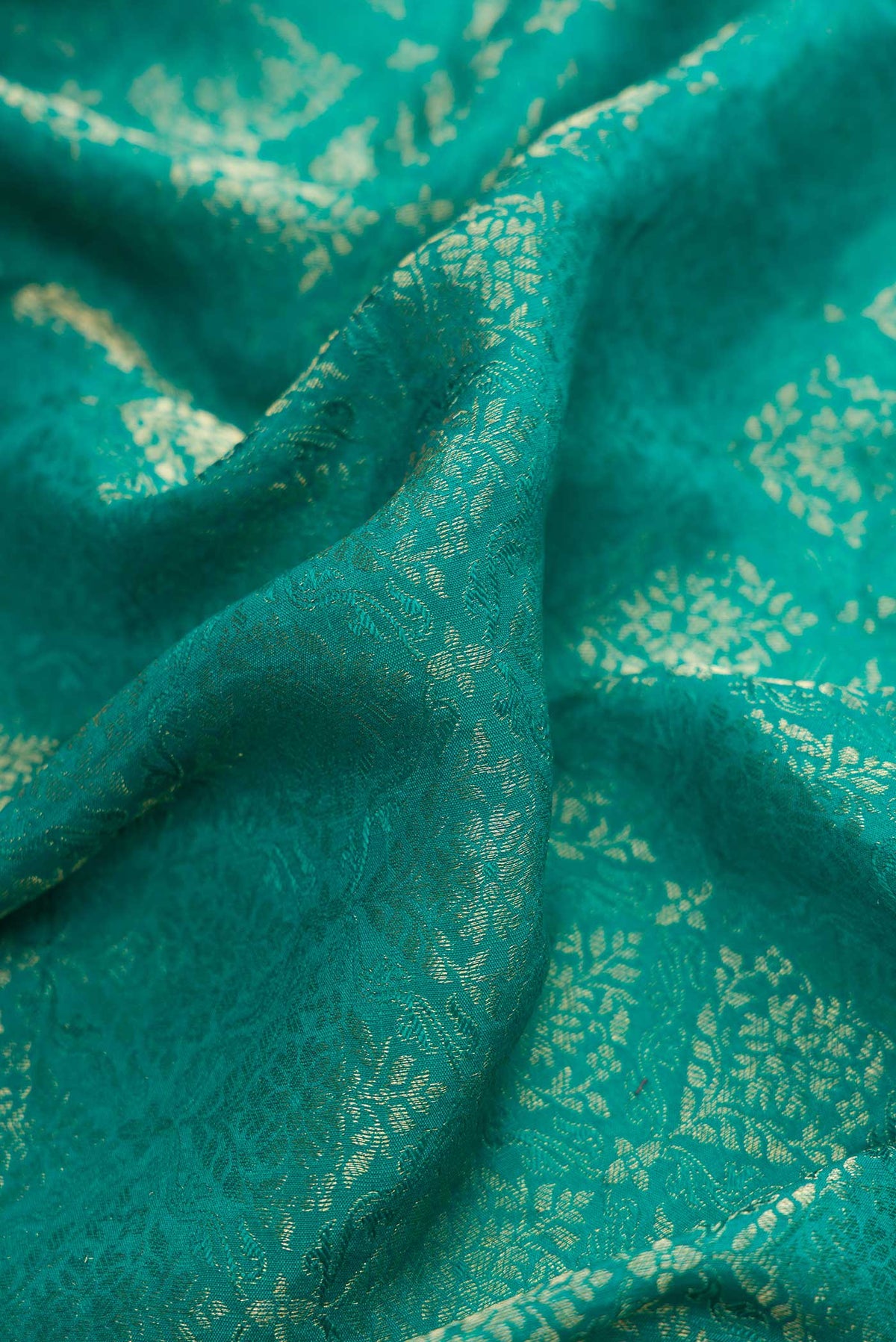 Close up of Peacock Blue Dual Tone Banarasi Georgette Saree with Zari Brocade on the body and Zari Border.  displaying folds