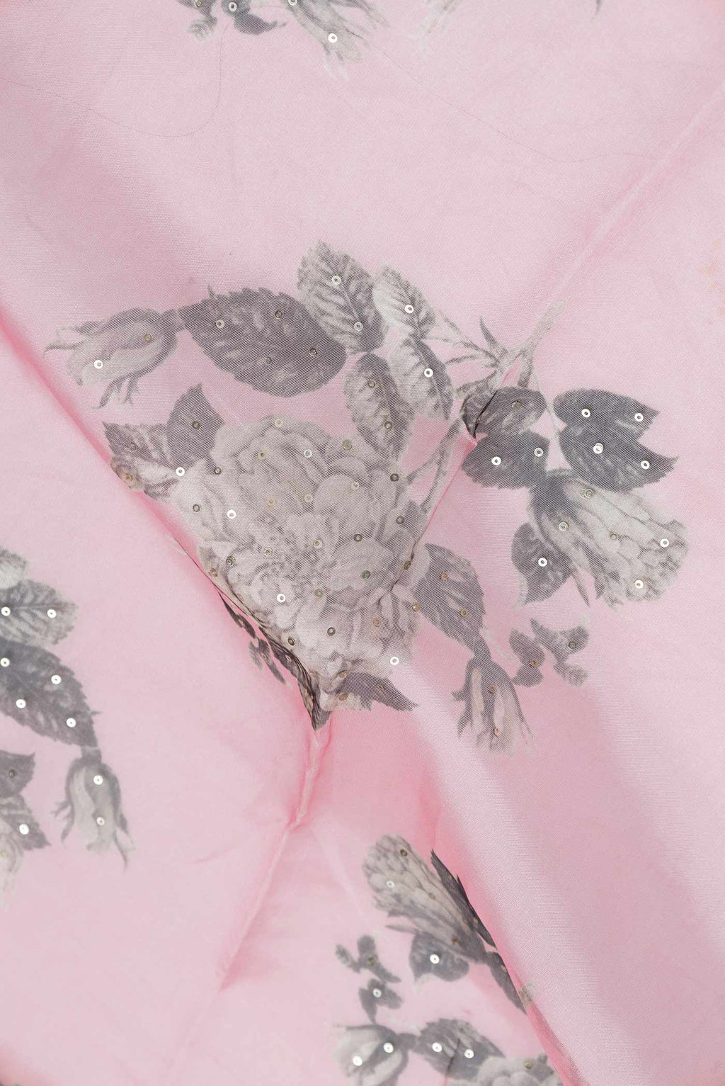 Close up of Pink Dual Tone Organza Silk Saree with Printed design on the body and Zari Border.  displaying folds