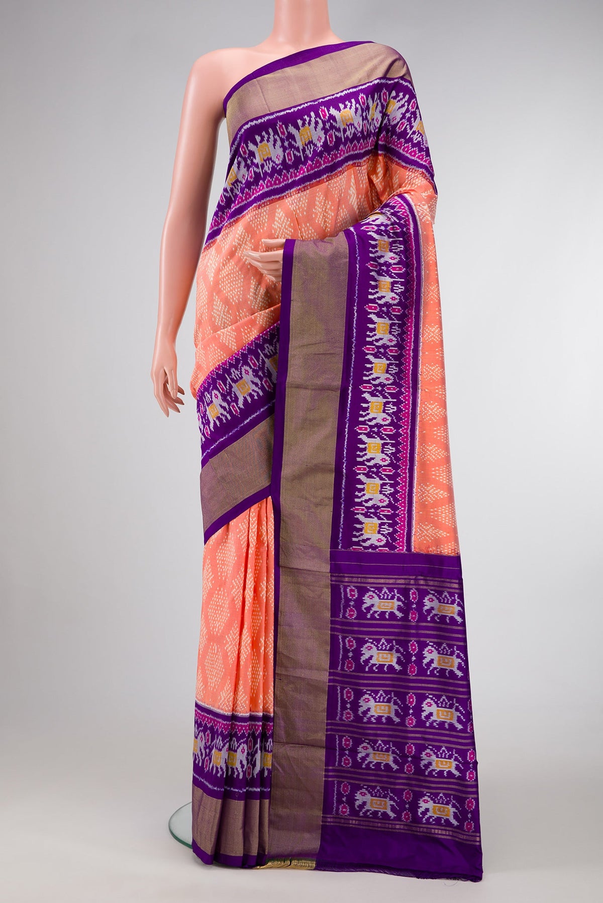 Golden Peach Dual Tone Double Ikat Saree with Ikat Print on the body and Ikat Border.  displayed on a mannequin