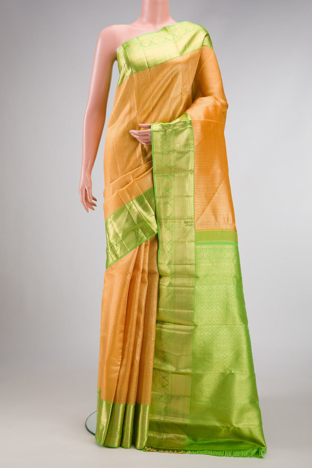 Golden Peach Dual Tone Kanchipuram Tissue Silk Saree with Zari Brocade on the body and Zari Border.  displayed on a mannequin
