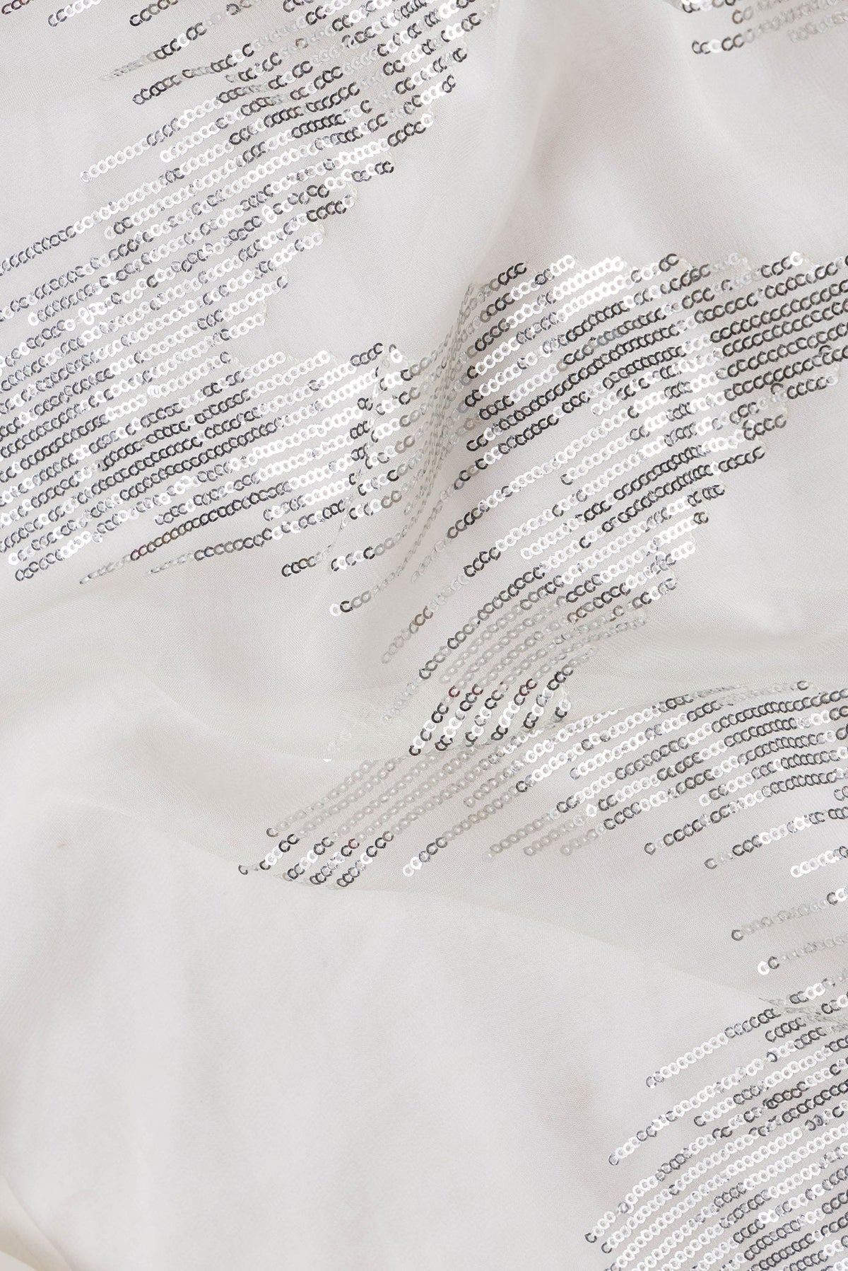 Close up of Off White Dual Tone Georgette Saree with Embroidery on the body and Without Border.  displaying folds