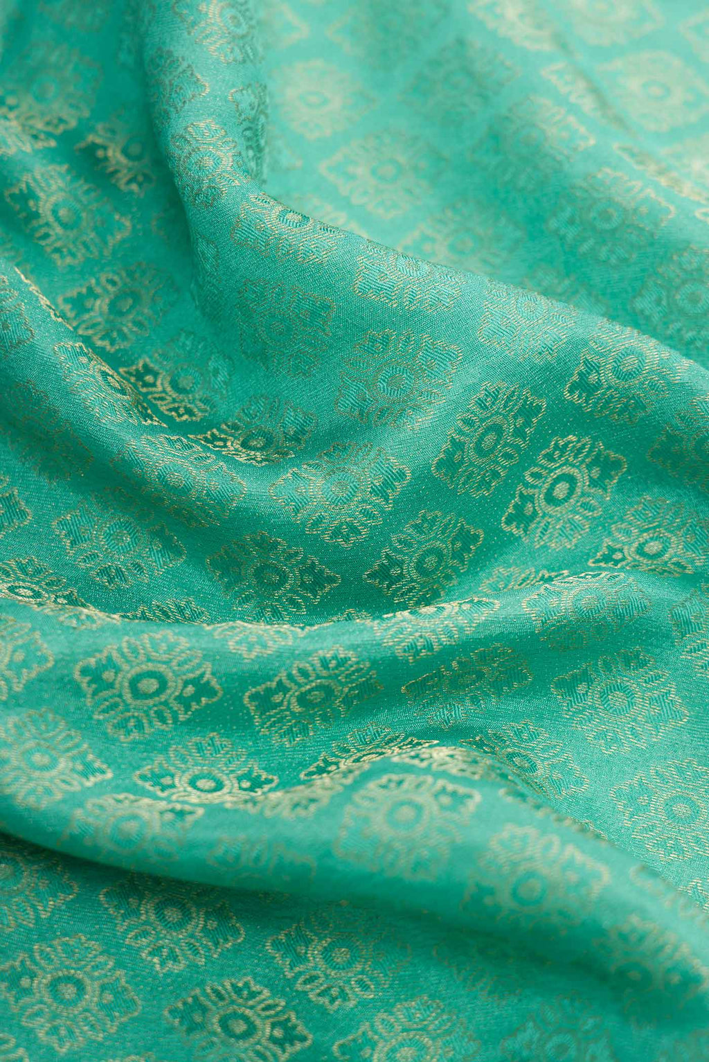 Close up of Sea Green Dual Tone Banarasi Georgette Saree with Zari Brocade on the body and Zari Border.  displaying folds