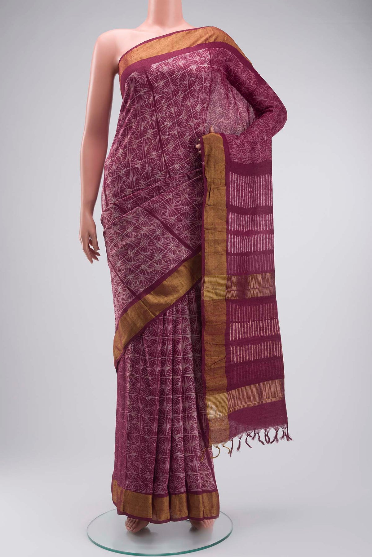 Mauve Tussar Silk Saree with Printed design on the body and Zari Border displayed on a mannequin