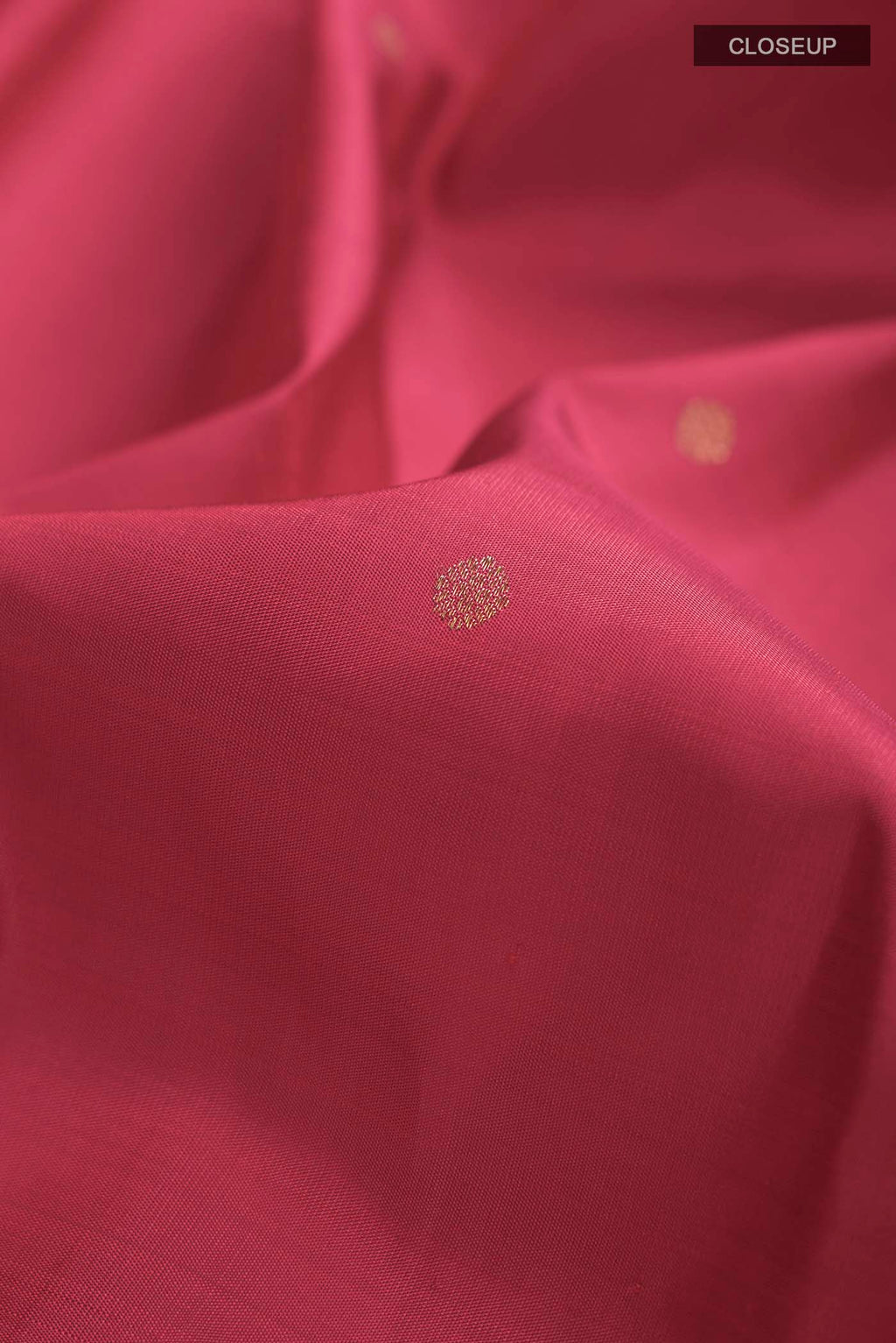 Close up of Red Kanchipuram Silk Saree with Zari Butta on the body and Zari Border displaying folds