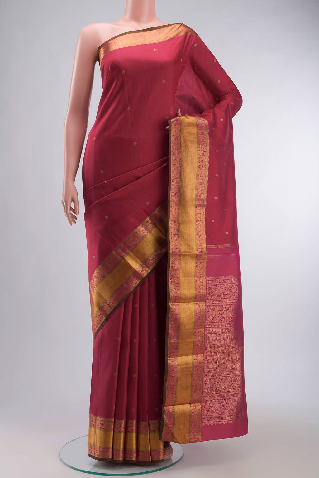 Red Kanchipuram Silk Saree with Zari Butta on the body and Zari Border displayed on a mannequin