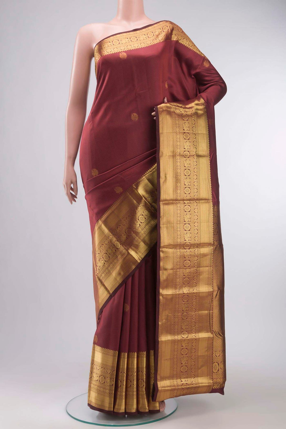 Maroon Kanchipuram Silk Saree with Jacquard With Zari Butta on the body and Zari Border displayed on a mannequin