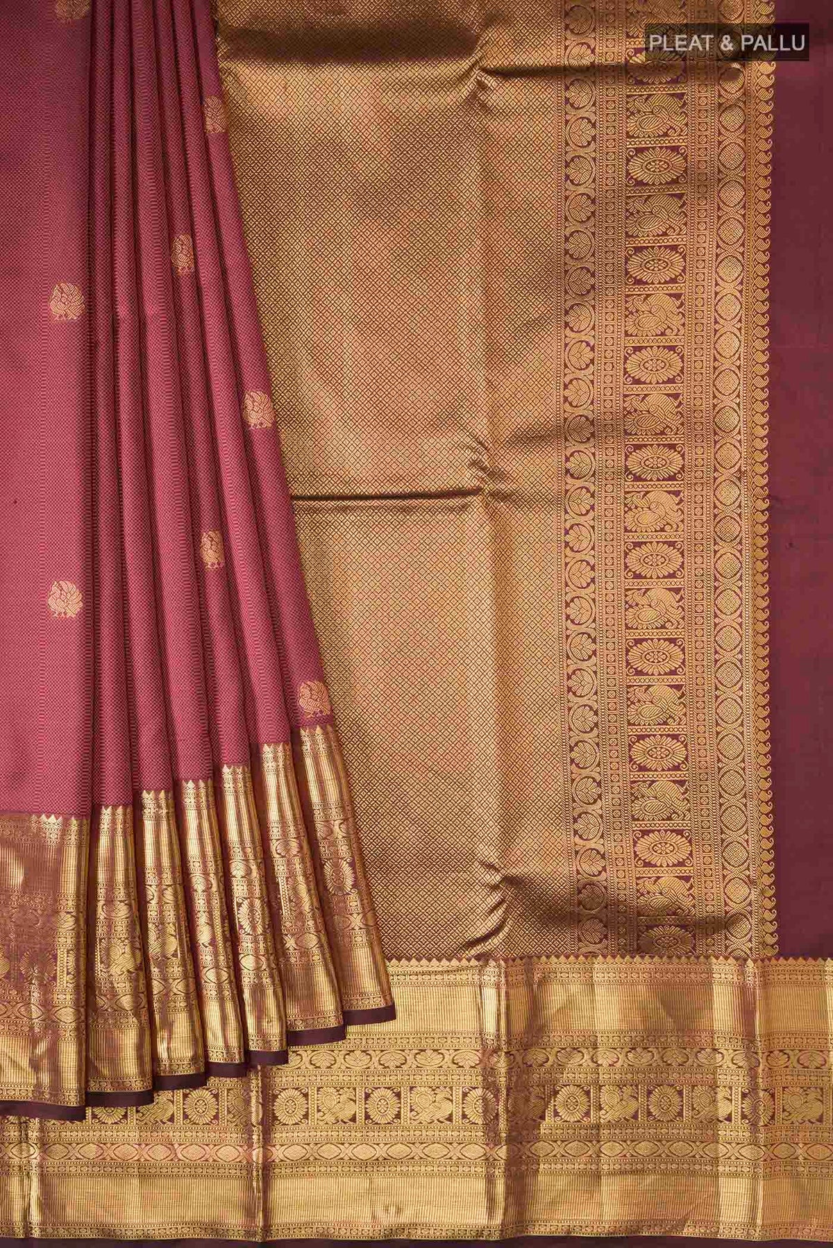 Pleats and pallu of Maroon Kanchipuram Silk Saree with Jacquard With Zari Butta on the body and Zari Border
