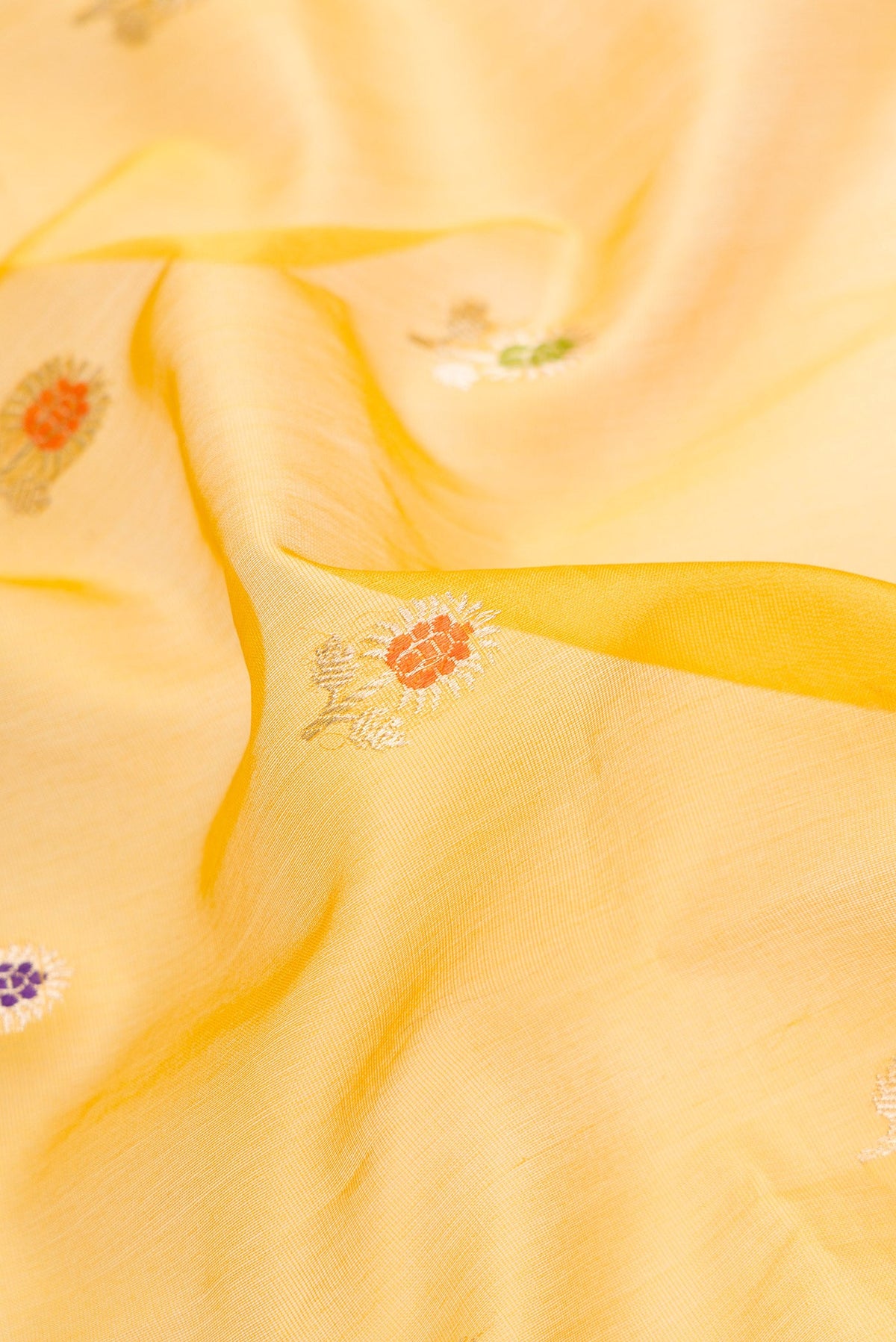 Close up of Mehandi Green Dual Tone Organza Silk Saree with Zari And Thread Butta on the body and Zari Border.  displaying folds