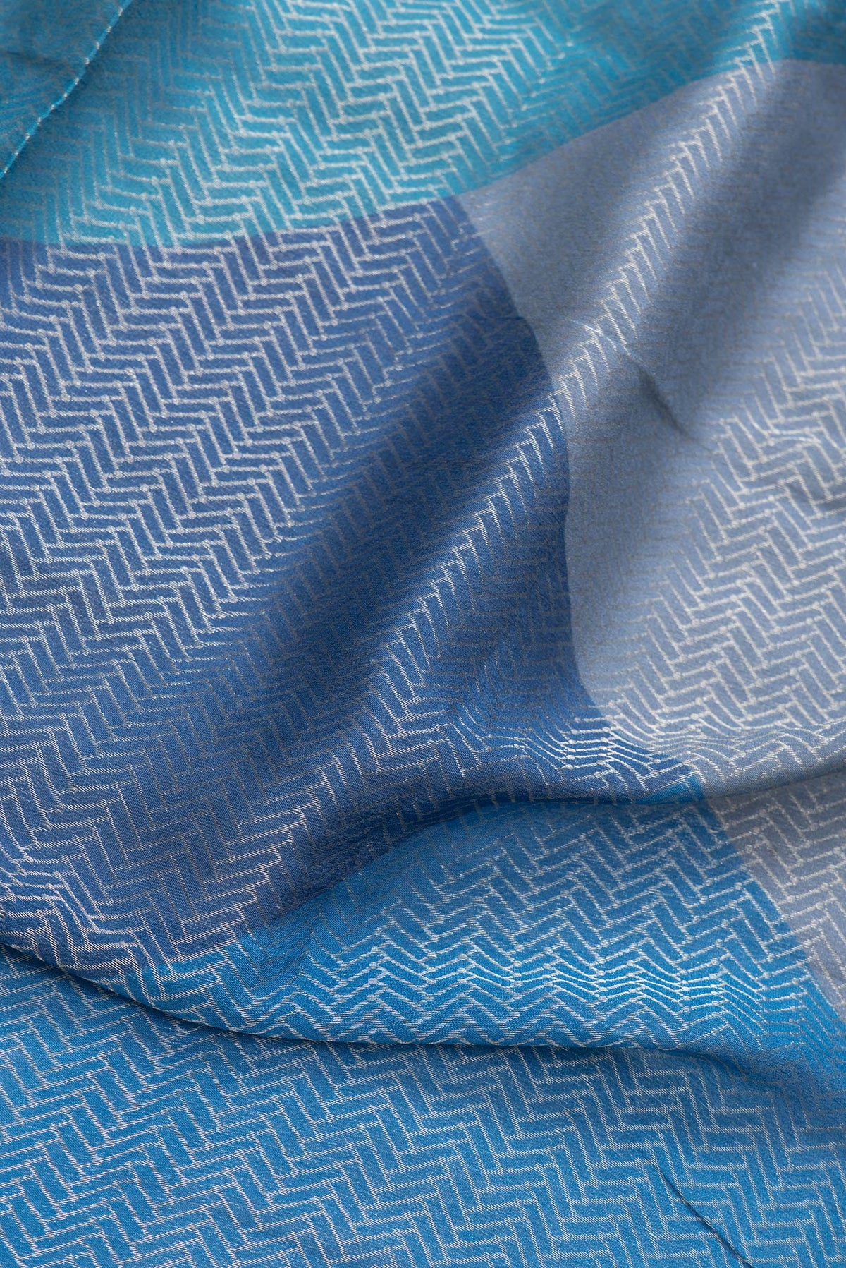 Close up of Navy Blue Dual Tone Georgette Saree with Zari Brocade on the body and Zari Border.  displaying folds