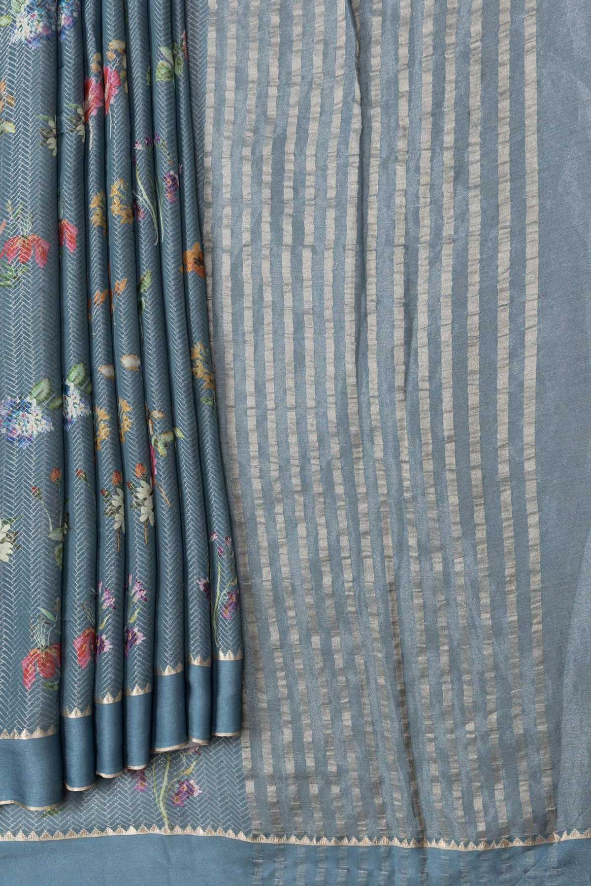 Pleats and pallu of Grey Dual Tone Georgette Saree with Zari Brocade on the body and Zari Border. 