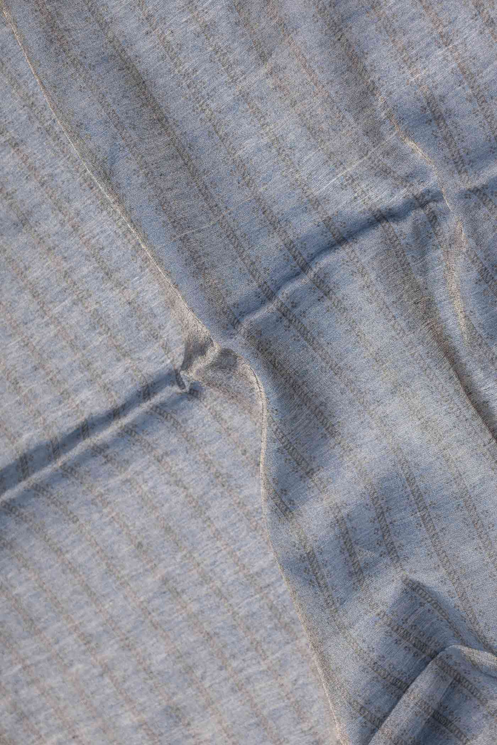 Close up of Blue Dual Tone Tussar Saree with Zari Brocade on the body and Embroidery Border displaying folds