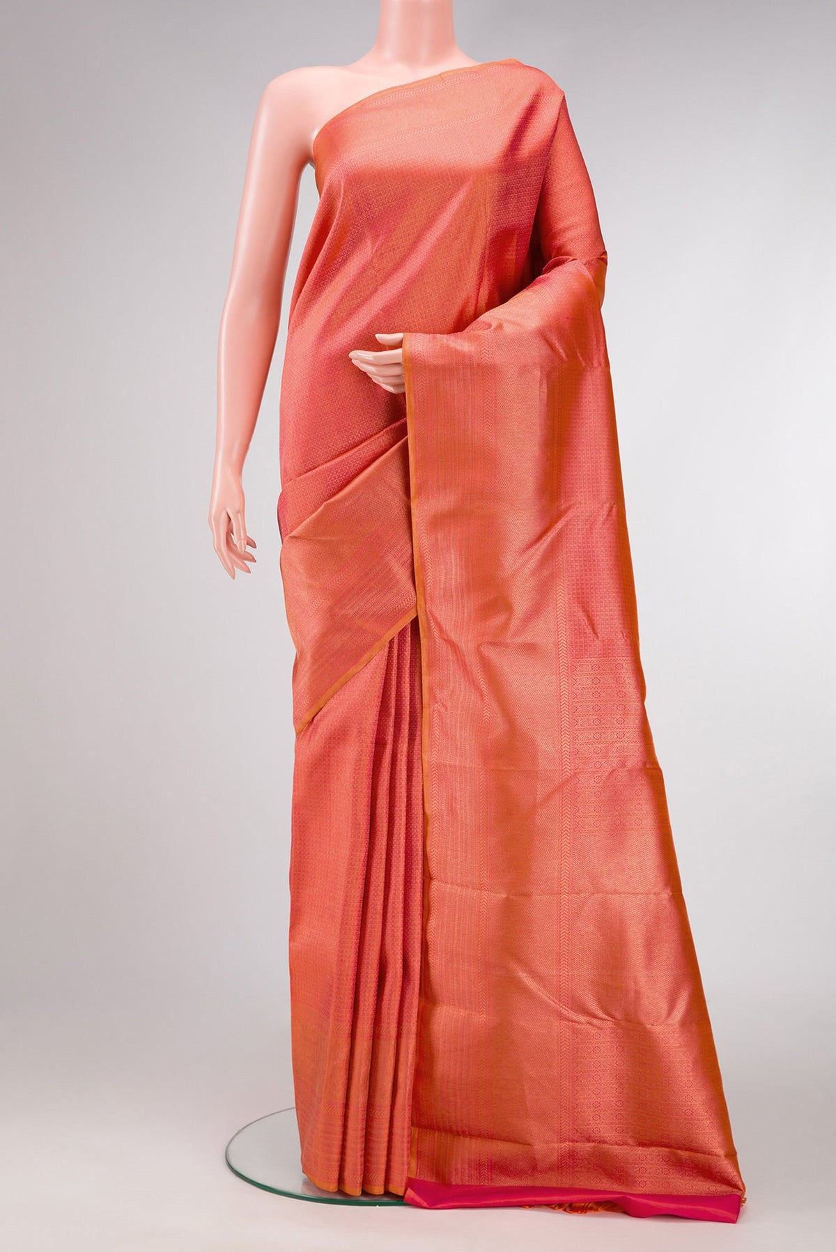 Brick Orange Dual Tone Kanjivaram Silk Saree with Zari Brocade on the body and Fancy Border.  displayed on a mannequin