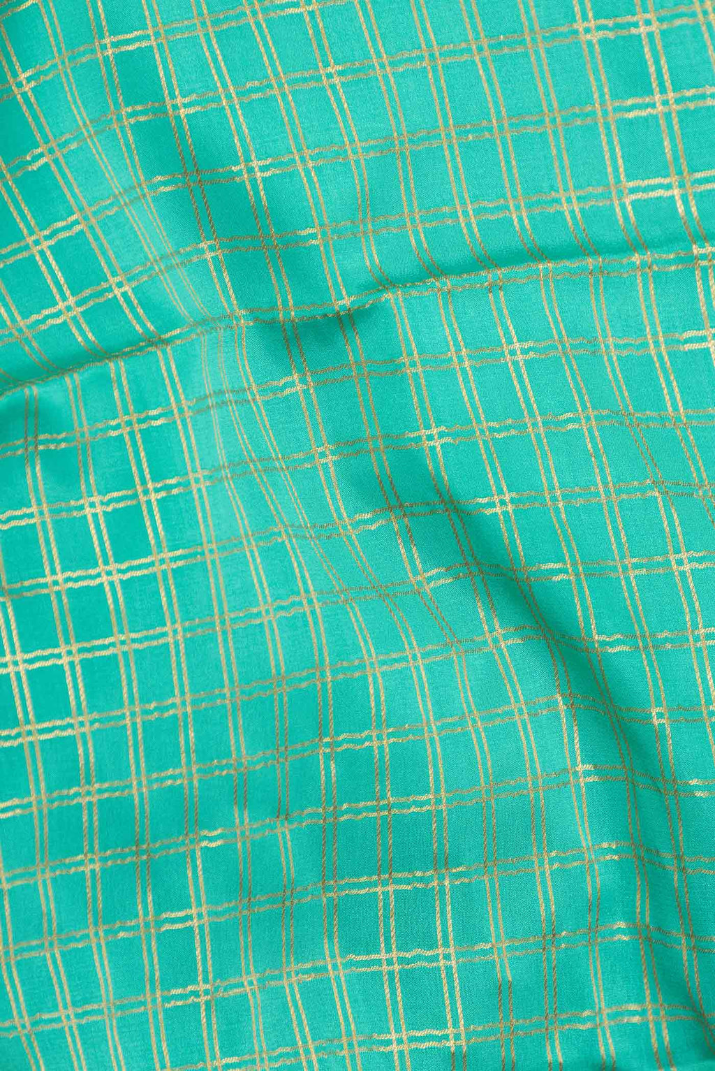 Close up of Sea Green Dual Tone Mysore Crepe Saree with Checked design on the body and Zari Border displaying folds
