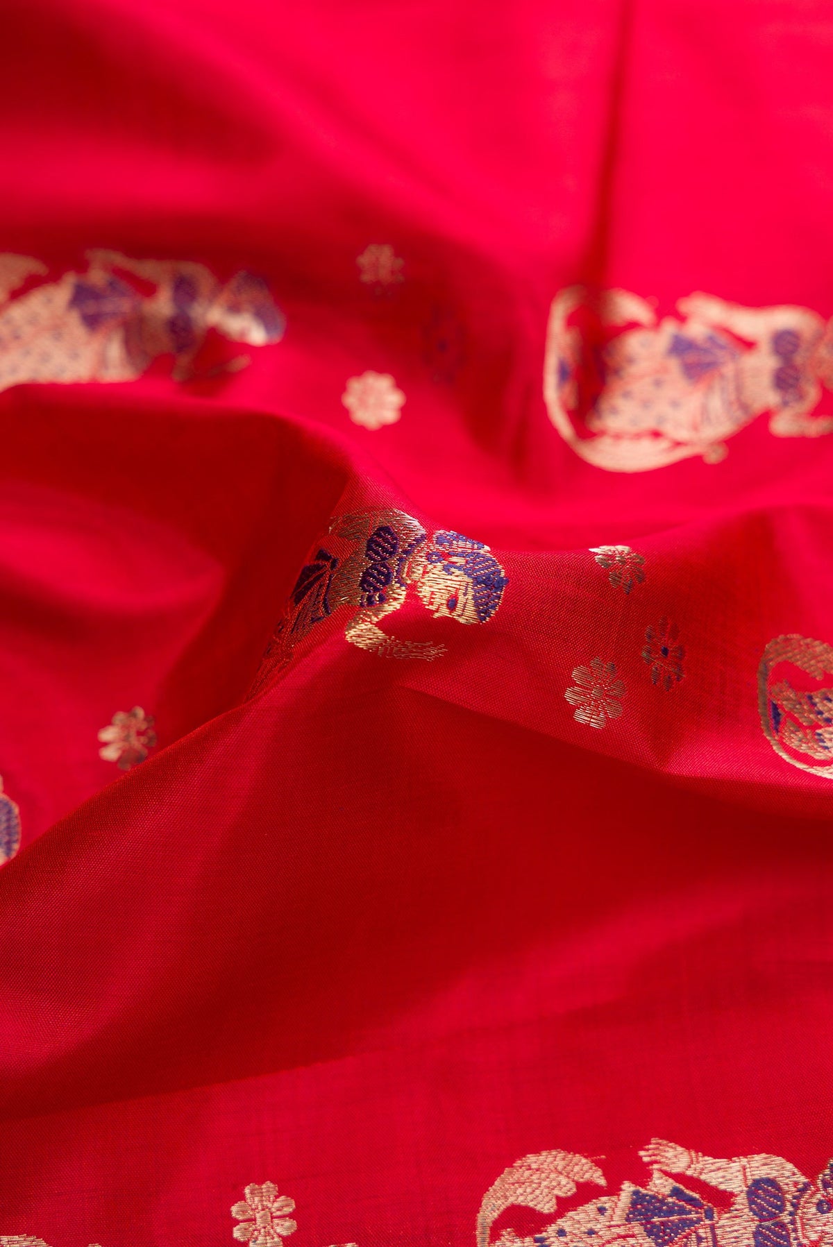 Close up of Dark Mauve Dual Tone Baluchari Silk Saree with Zari And Thread Butta on the body and Fancy Border.  displaying folds