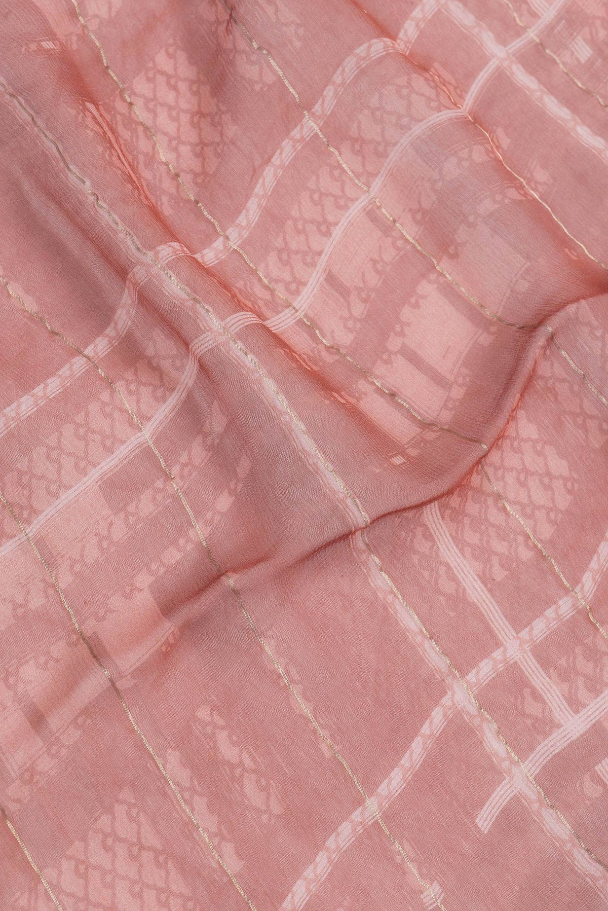 Close up of Bronze Dual Tone Mysore Georgette Saree with Printed design on the body and Zari Border.  displaying folds