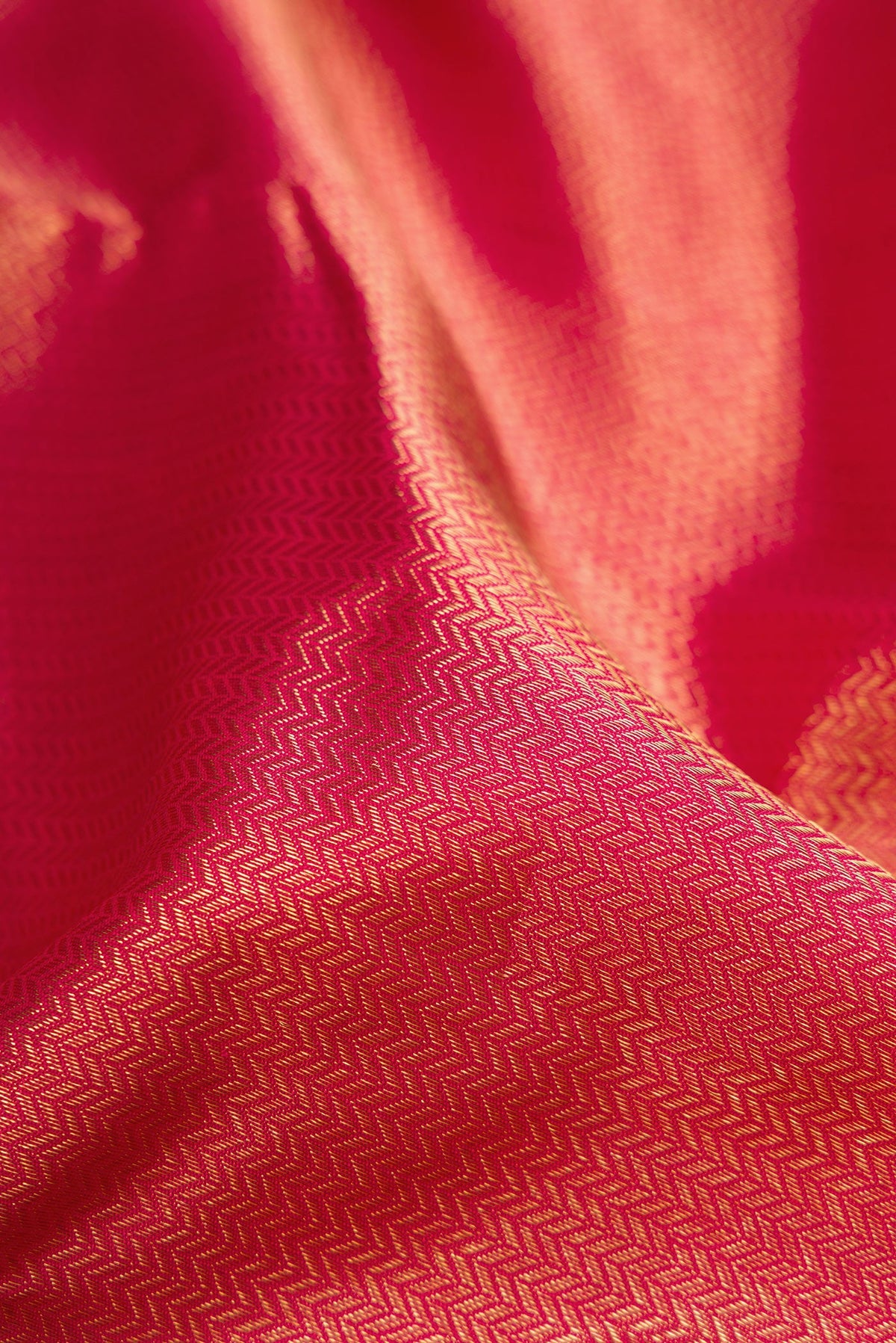 Close up of Pure Silk Pure Zari Maroon Dual Tone Kanjivaram Saree with Zari Brocade on the body and Zari Border.  displaying folds
