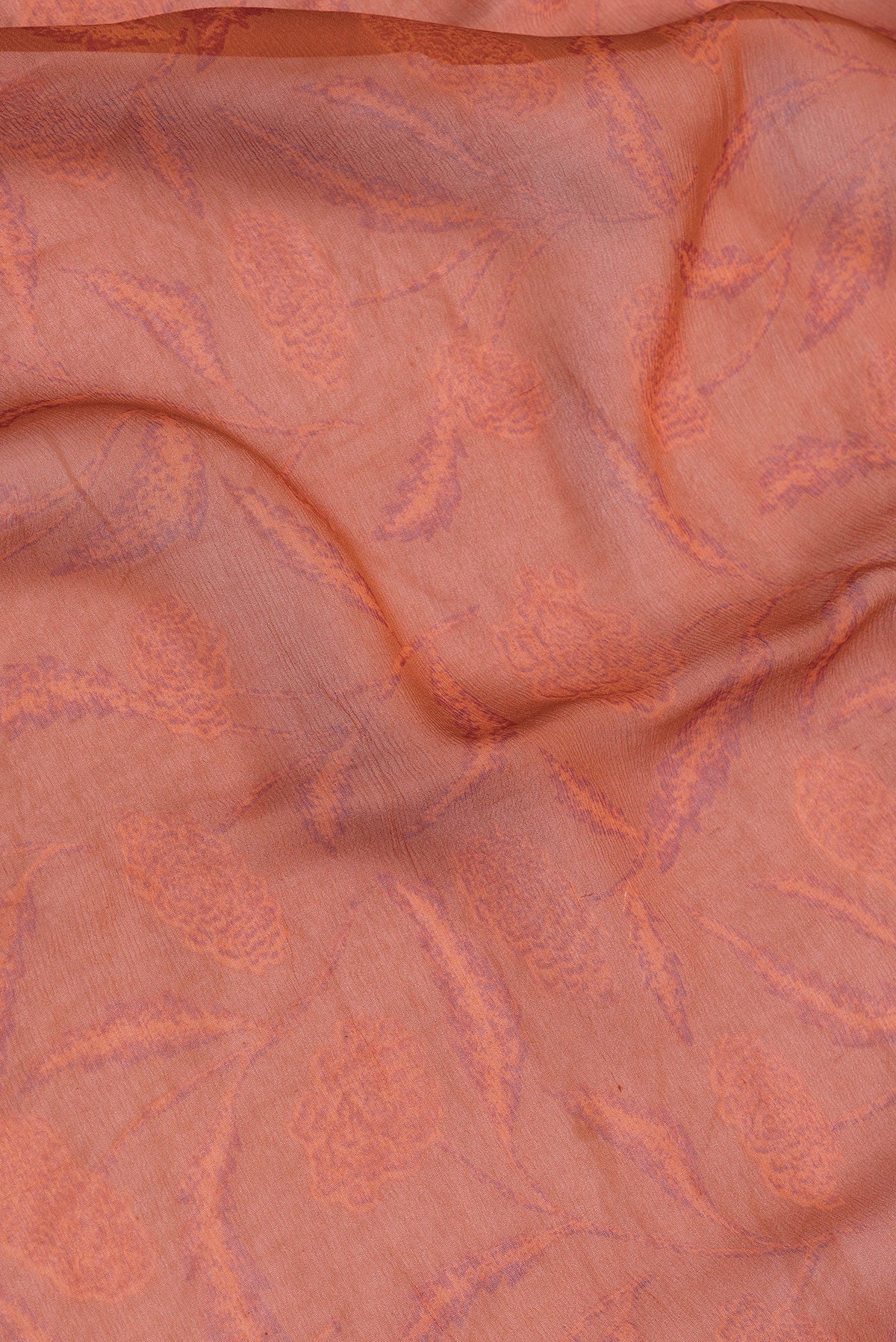 Close up of Orange Dual Tone Mysore Chiffon Saree with Printed design on the body and Plain Border.  displaying folds