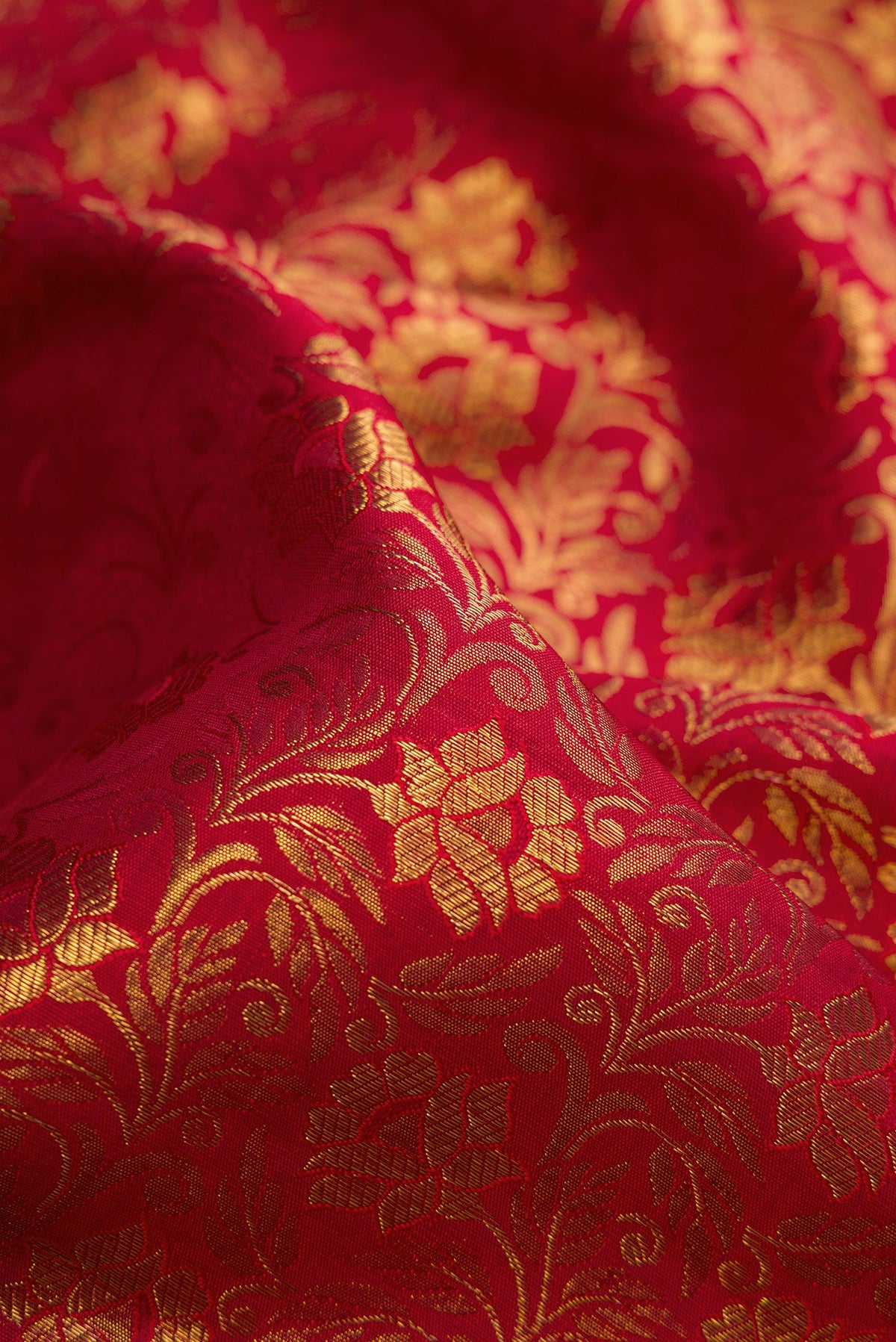 Close up of Pure Silk Pure Zari Maroon Kanjivaram Saree with Jacquard design on the body and Zari Border.  displaying folds