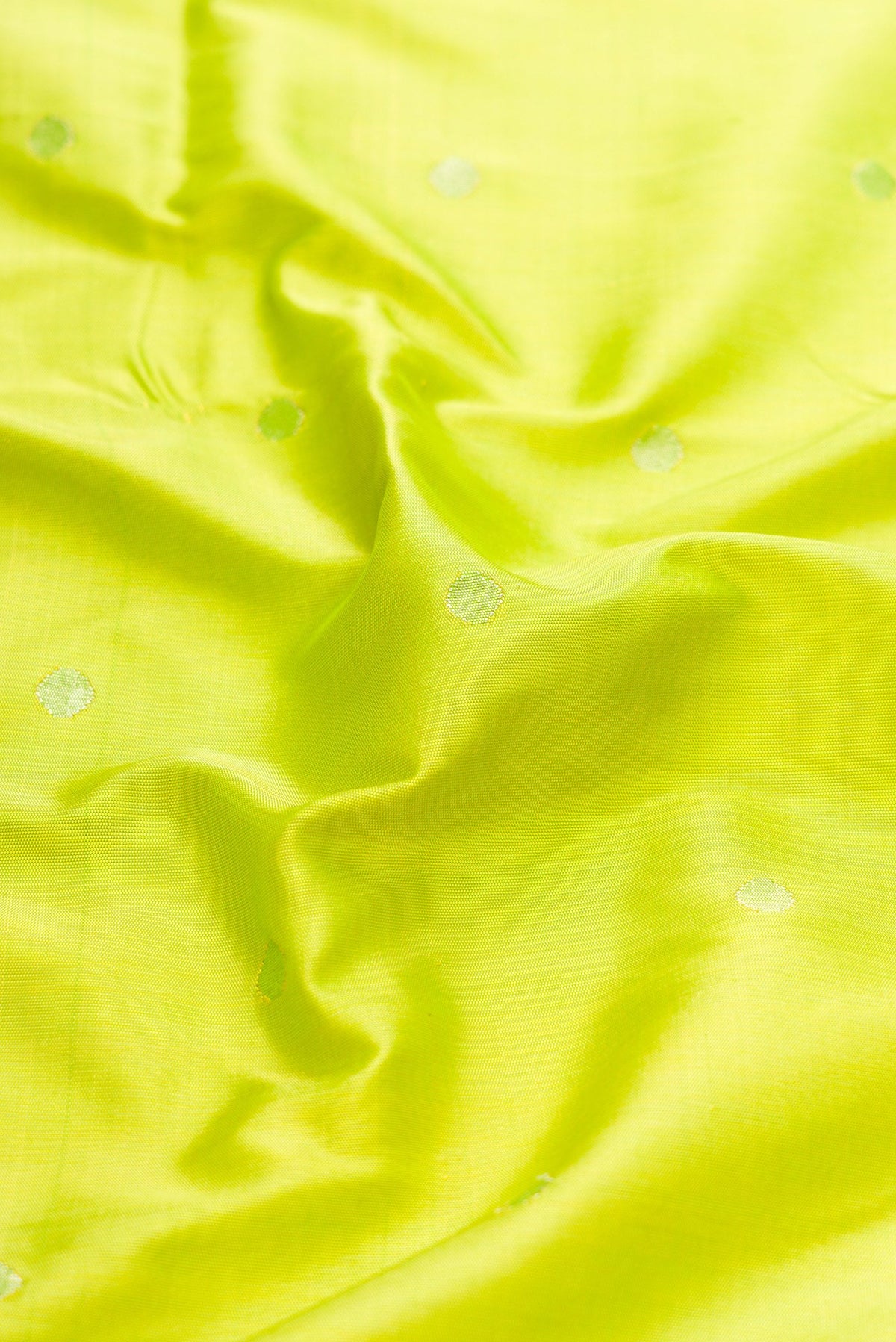 Close up of Parrot Green Dual Tone Paithani Silk Saree with Zari Butta on the body and Paithani Border.  displaying folds