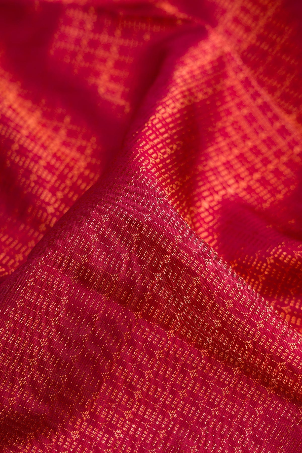 Close up of Maroon Dual Tone Kanchipuram Silk Saree with Zari Brocade on the body and Zari Border.  displaying folds