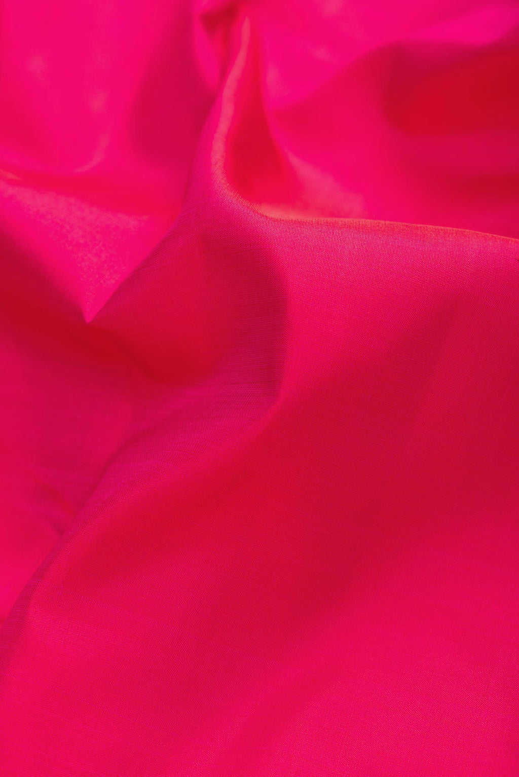 Close up of Dark Pink Dual Tone Kanchipuram Silk Saree with Plain Body and Zari Border displaying folds