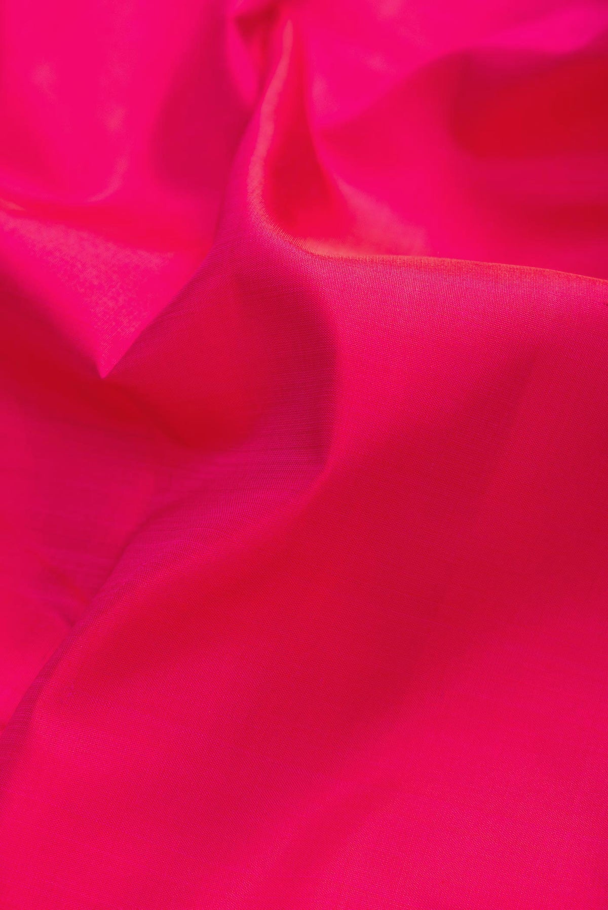 Close up of Dark Pink Dual Tone Kanchipuram Silk Saree with Plain Body and Zari Border displaying folds