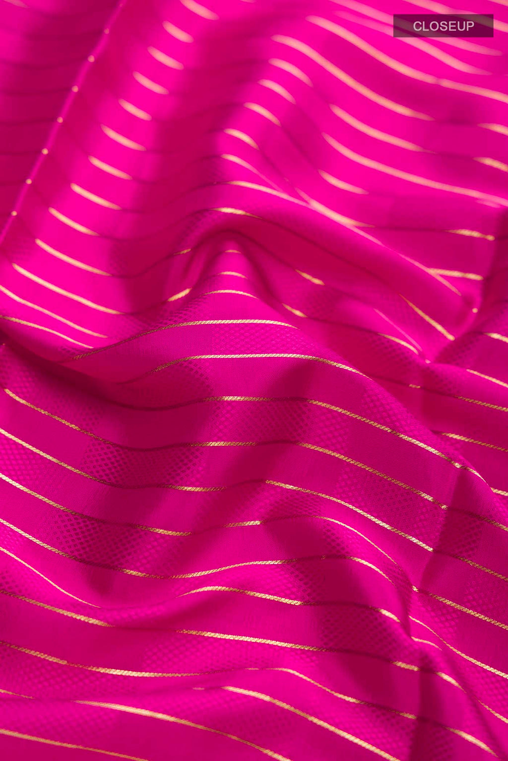 Close up of Pink Mysore Crepe Saree with Stripes on the body and Zari Border displaying folds