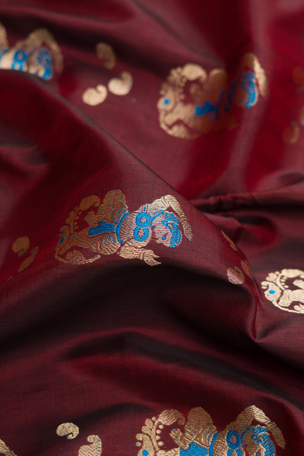 Close up of Coffee Brown Baluchari Silk Saree with Thread Butta on the body and Zari Border.  displaying folds