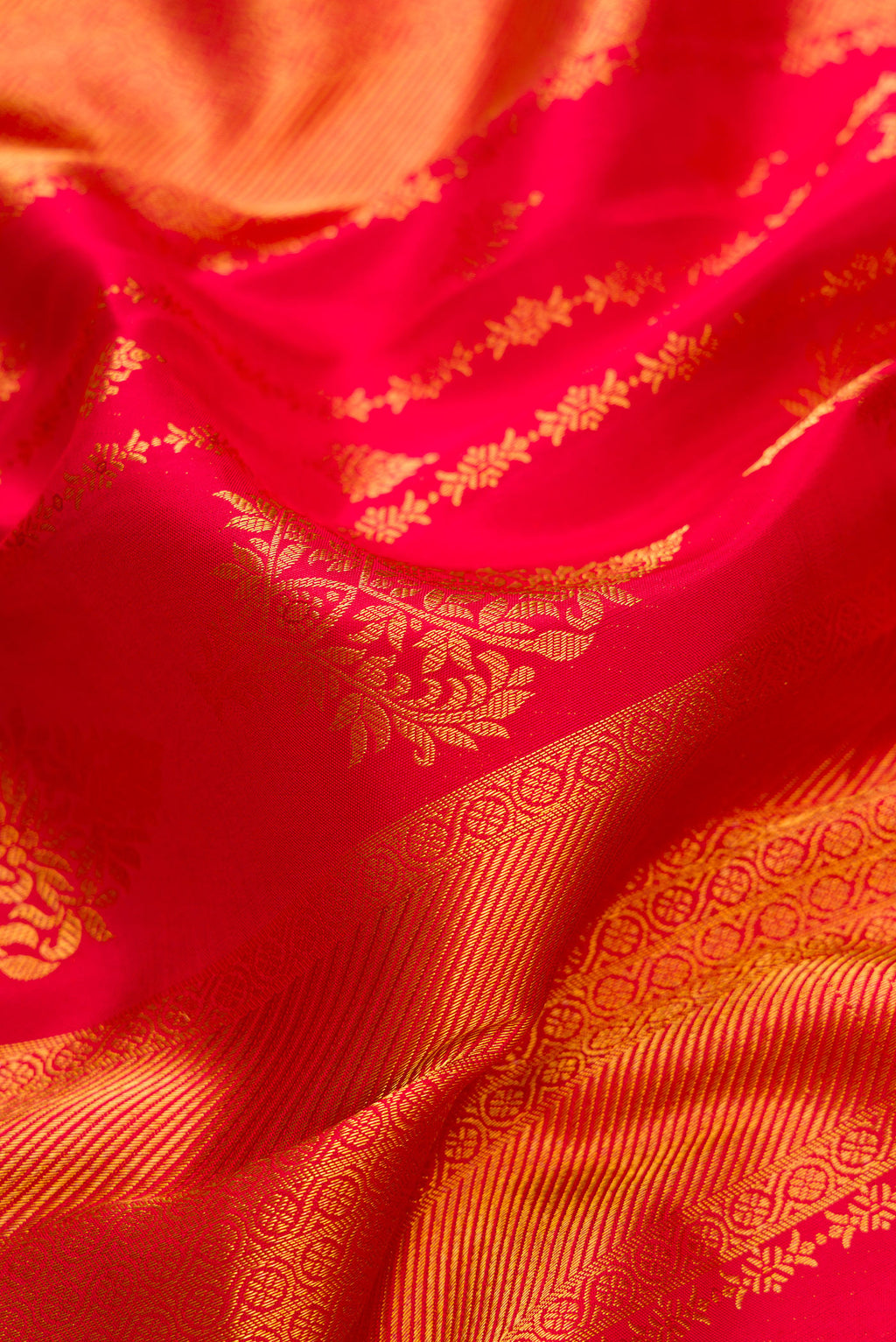 Close up of Red Kanjivaram Silk Saree with Zari Brocade on the body and Zari Border.  displaying folds