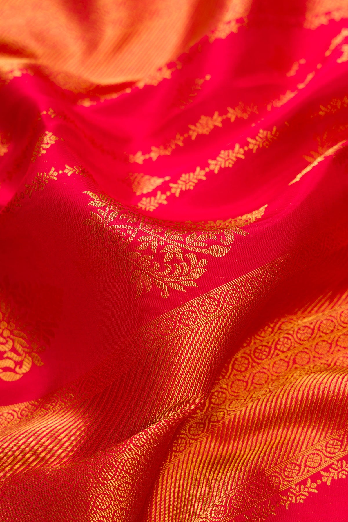 Close up of Red Kanjivaram Silk Saree with Zari Brocade on the body and Zari Border.  displaying folds