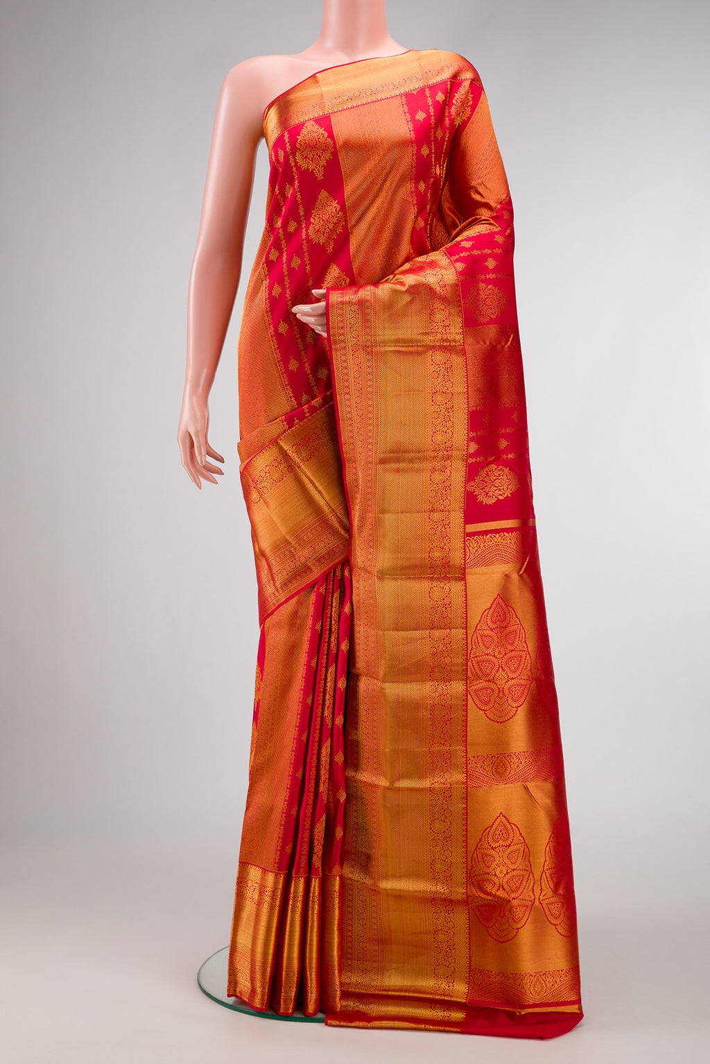 Red Kanjivaram Silk Saree with Zari Brocade on the body and Zari Border.  displayed on a mannequin
