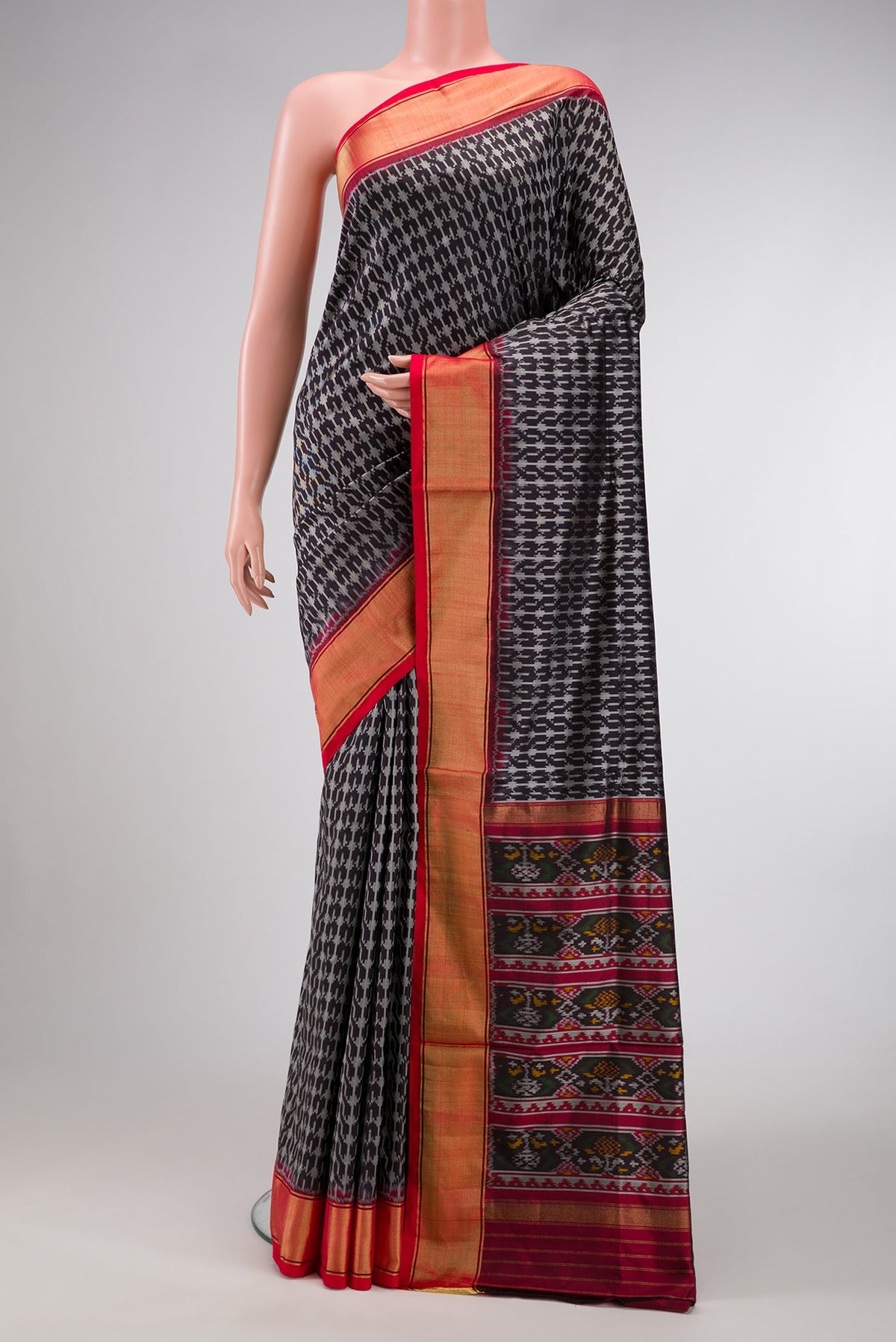 Black Dual Tone Double Ikat Saree with Ikat Print on the body and Zari Border.  displayed on a mannequin