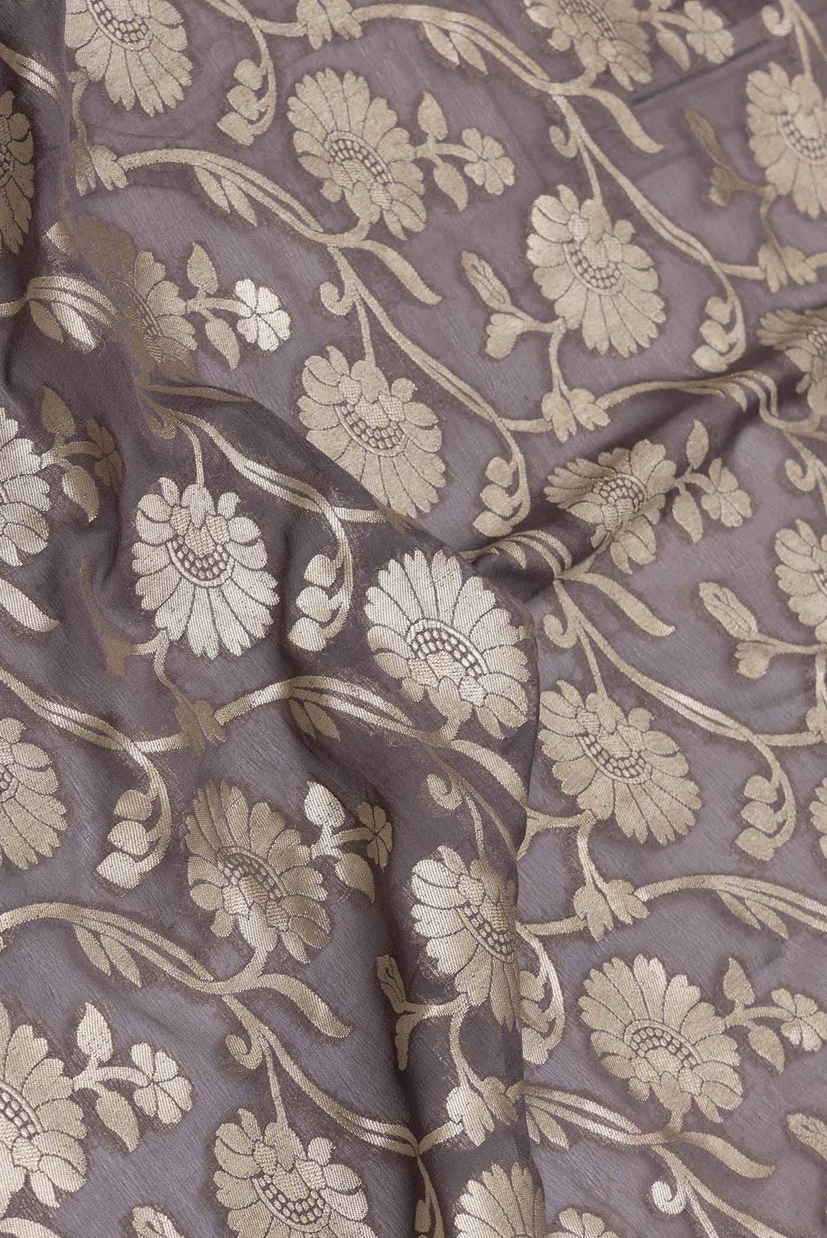 Close up of Brown Dual Tone Blended Banarasi Georgette Saree with Zari Brocade on the body and Zari Border displaying folds