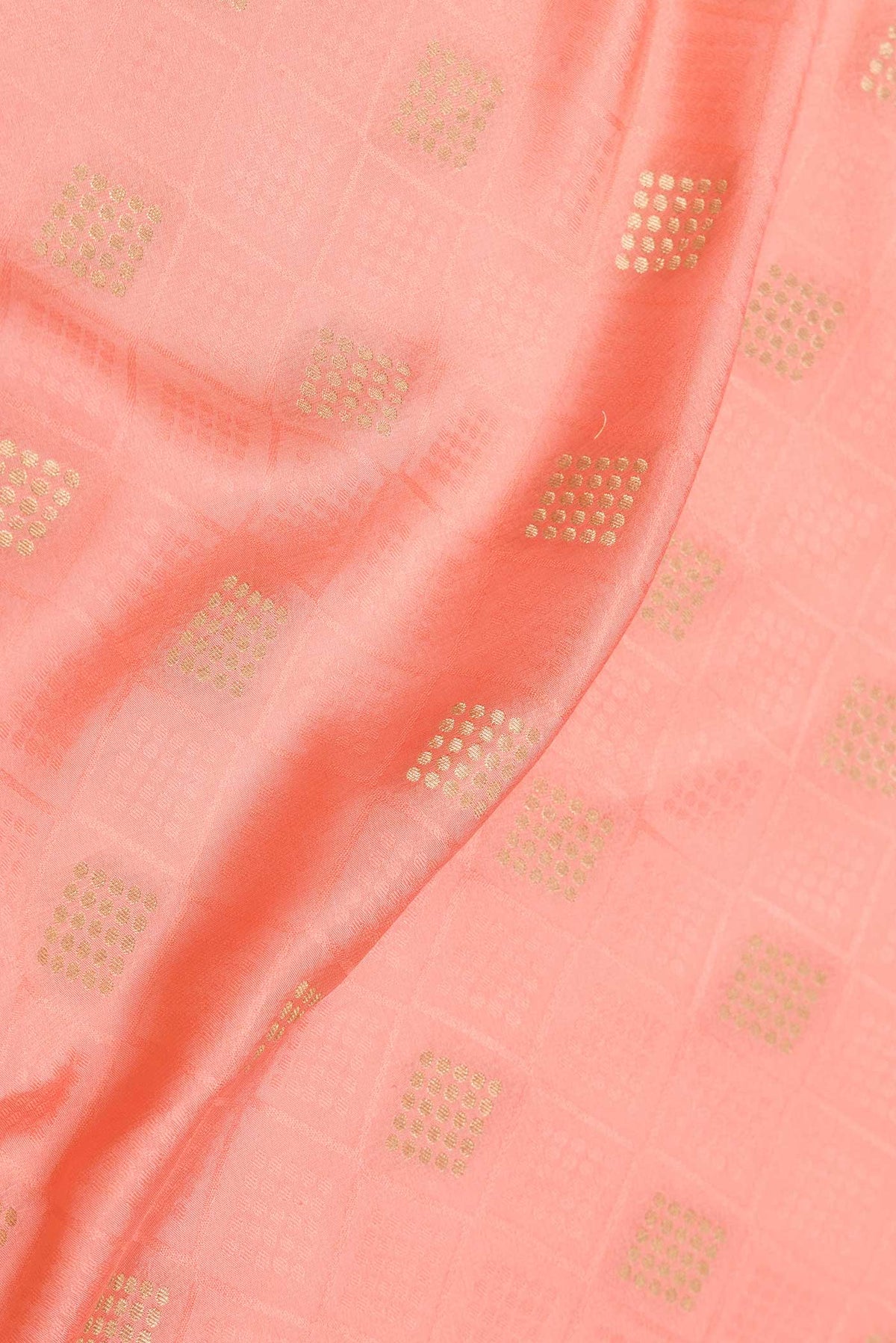 Close up of Golden Peach Dual Tone Mysore Crepe Saree with Jacquard With Zari Butta on the body and Zari Border displaying folds