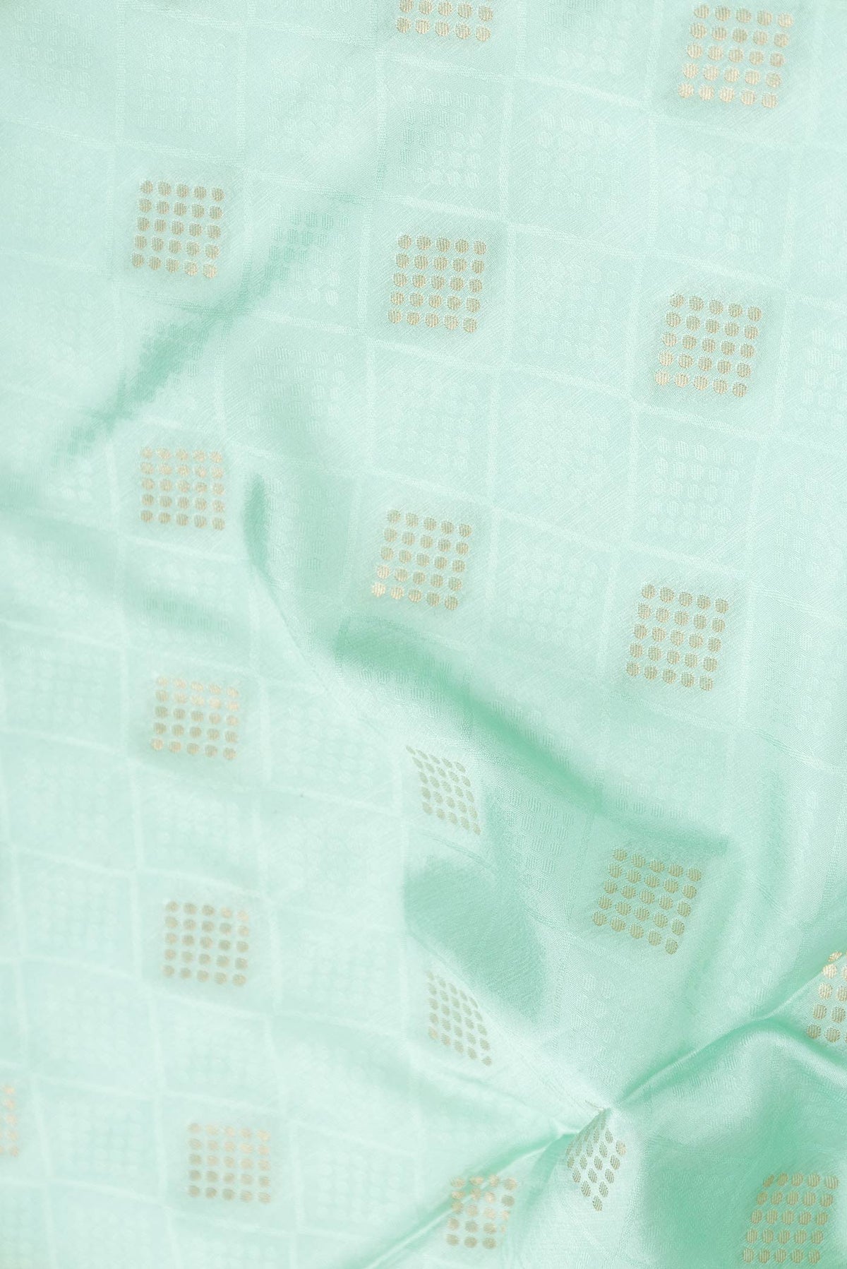 Close up of Sea Green Dual Tone Mysore Crepe Saree with Jacquard With Zari Butta on the body and Zari Border displaying folds