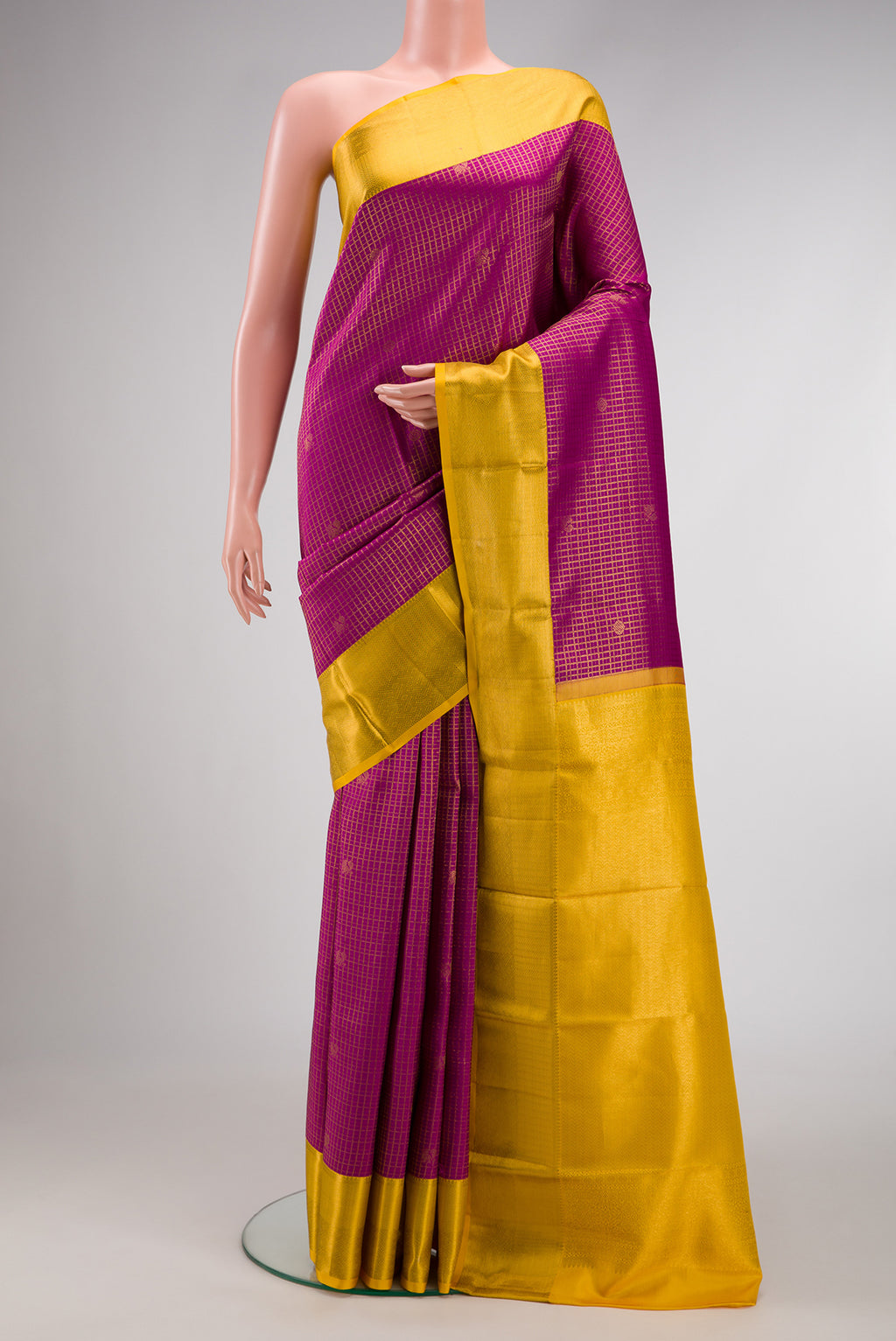 Magenta Kanjivaram Silk Saree with Zari Brocade on the body and Zari Border.  displayed on a mannequin