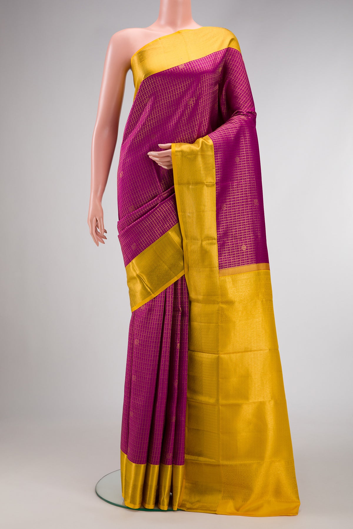 Magenta Kanjivaram Silk Saree with Zari Brocade on the body and Zari Border.  displayed on a mannequin