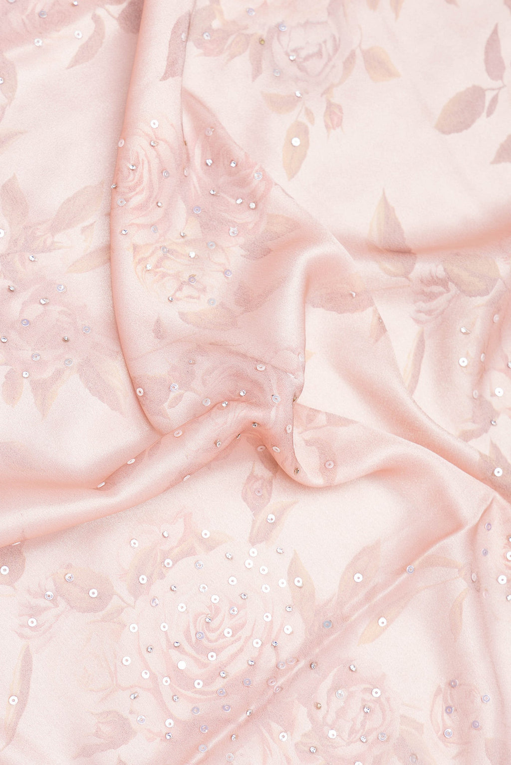 Close up of Rose Gold Dual Tone Georgette Saree with Embroidery on the body and Embroidery Border.  displaying folds