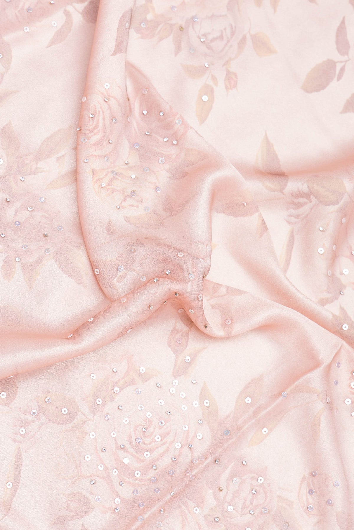 Close up of Rose Gold Dual Tone Georgette Saree with Embroidery on the body and Embroidery Border.  displaying folds