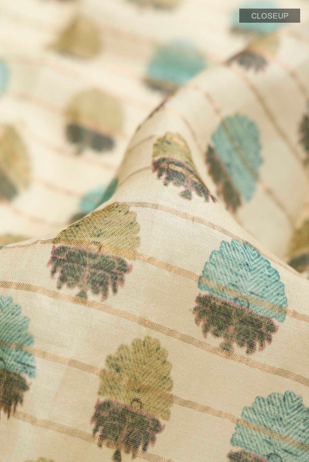 Close up of Green Bhagalpuri Tussar Silk Saree with Printed design on the body and Zari Border displaying folds